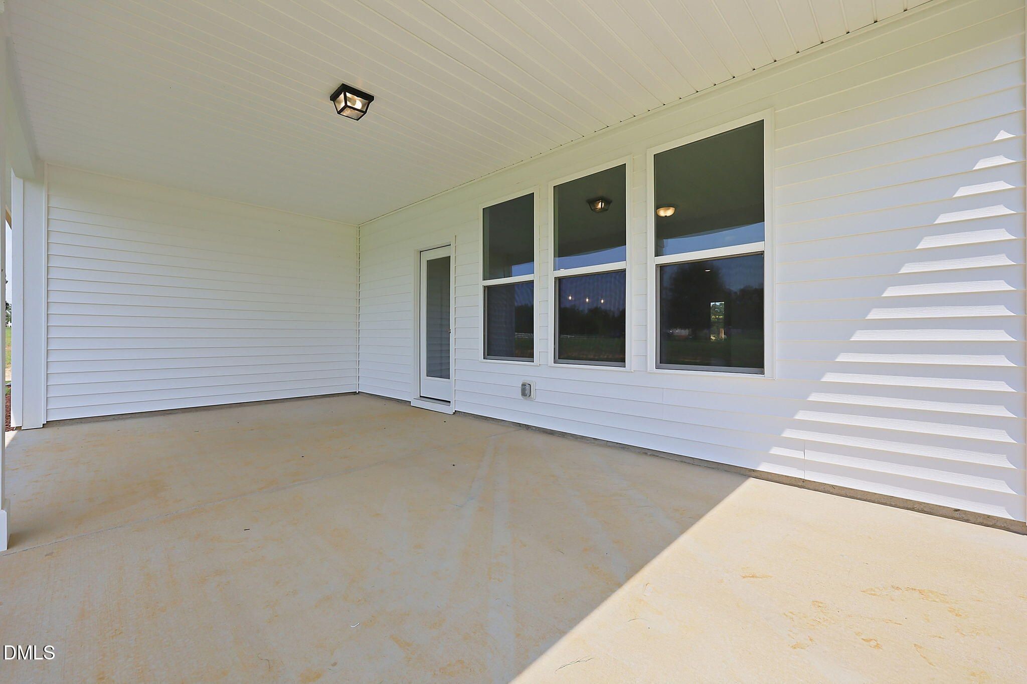 Covered back patio of The Magnolia B floor plan at Retreat at North Main in Lillington, NC by Davidson Homes.