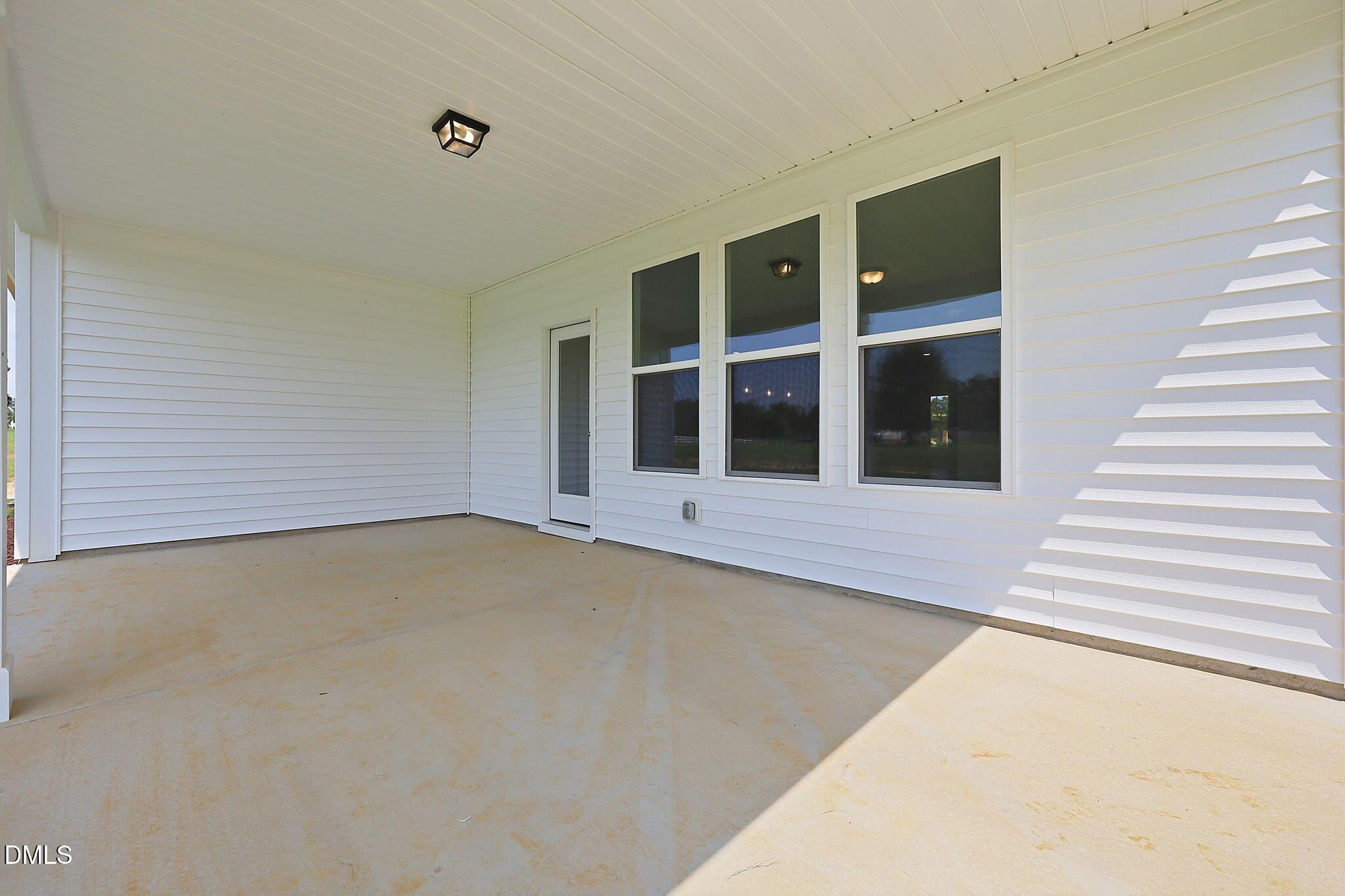Covered back patio of The Magnolia B floor plan at Retreat at North Main in Lillington, NC by Davidson Homes.
