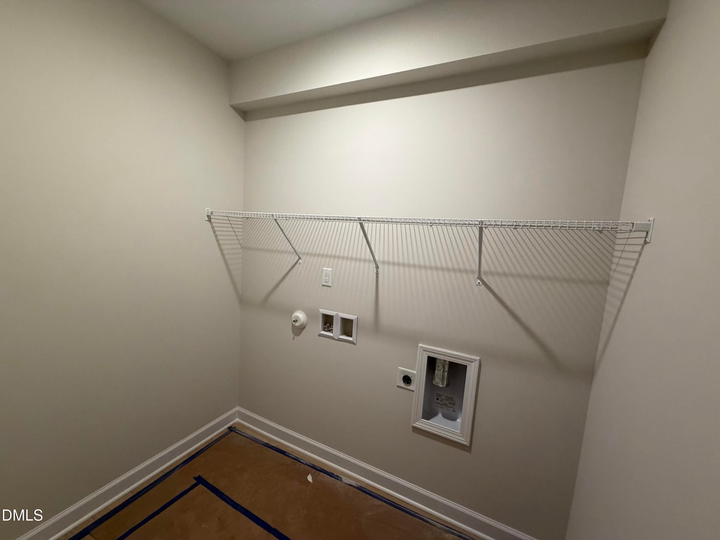 Spacious laundry room with wire shelving, washer dryer hookups in The Daphne C by Davidson Homes, Wellers Knoll, Lillington, NC