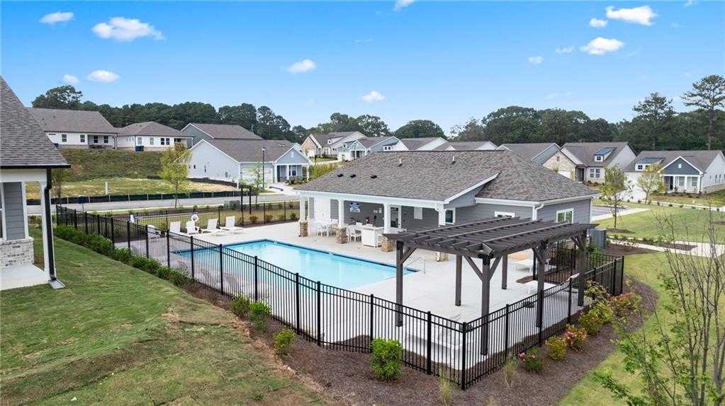 Inviting community pool with pergola lounge area and modern homes in Kelly Preserve, Loganville, Georgia