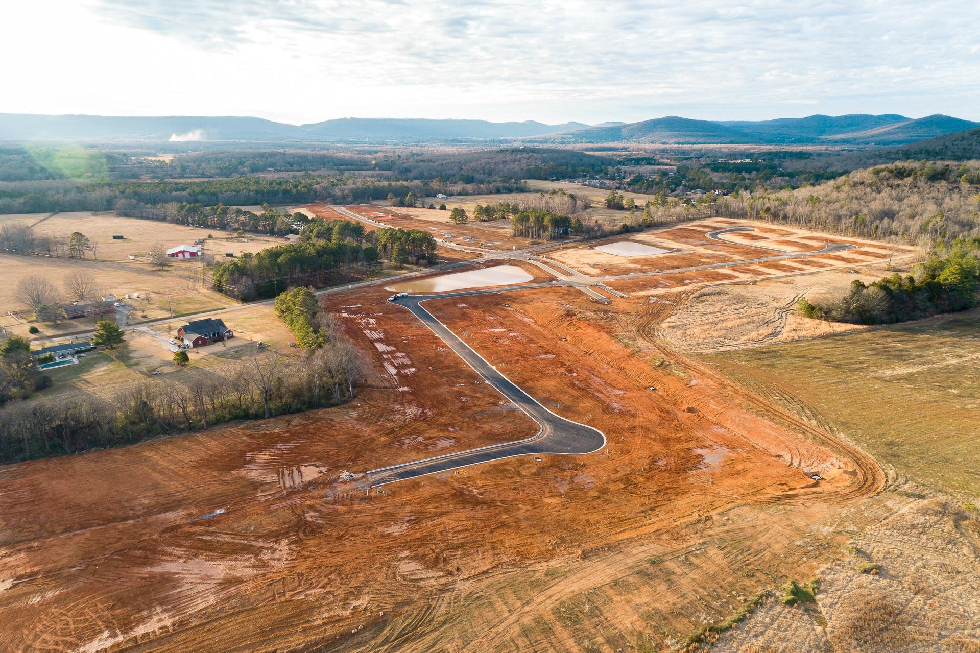 Aerial view of Mountain Preserve development in Hampton Cove Alabama featuring new roads home sites and scenic mountain backdrop