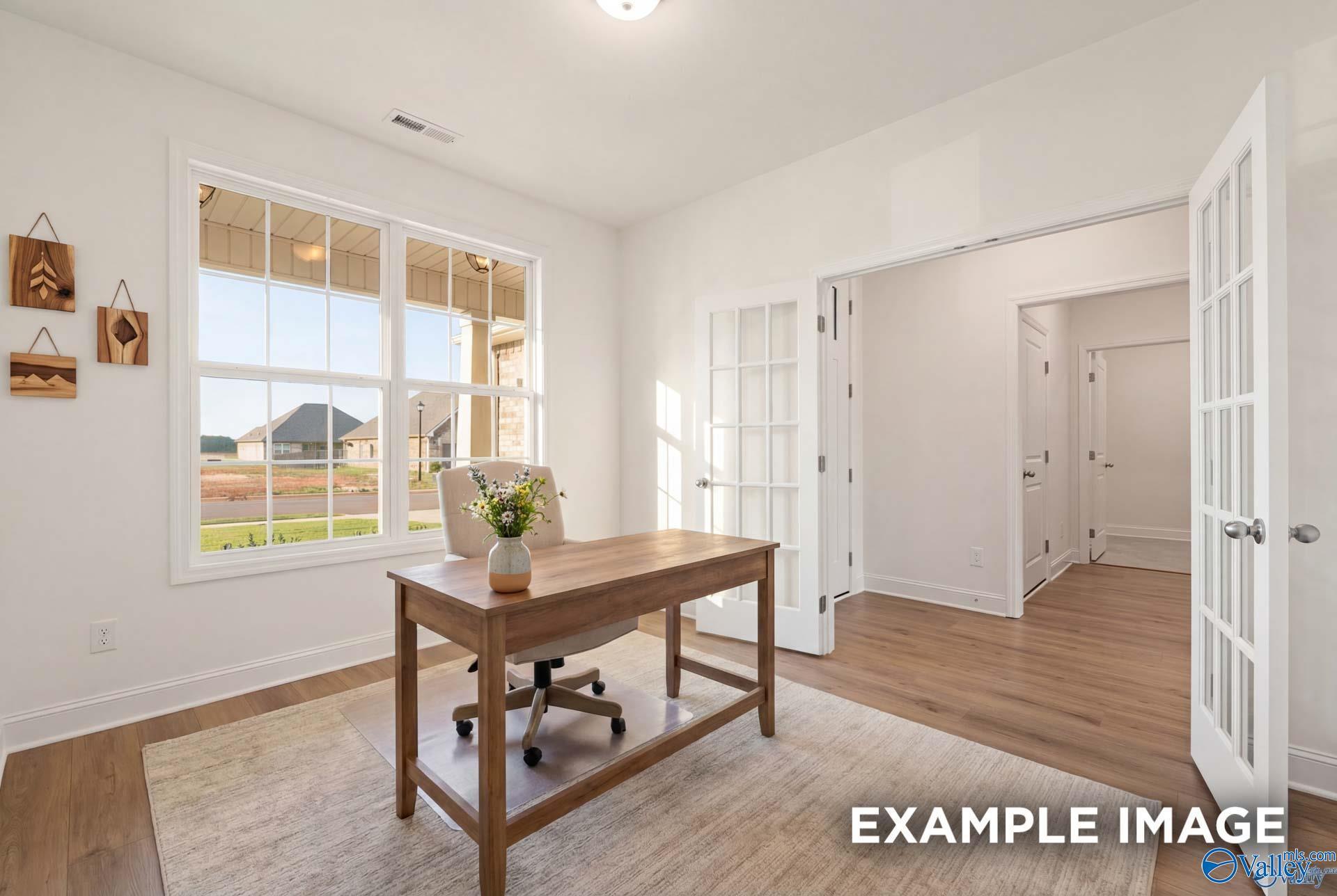 Bright home office with French doors and wood floors in The Rockford B floor plan at Kendall Downs, Toney, Alabama.
