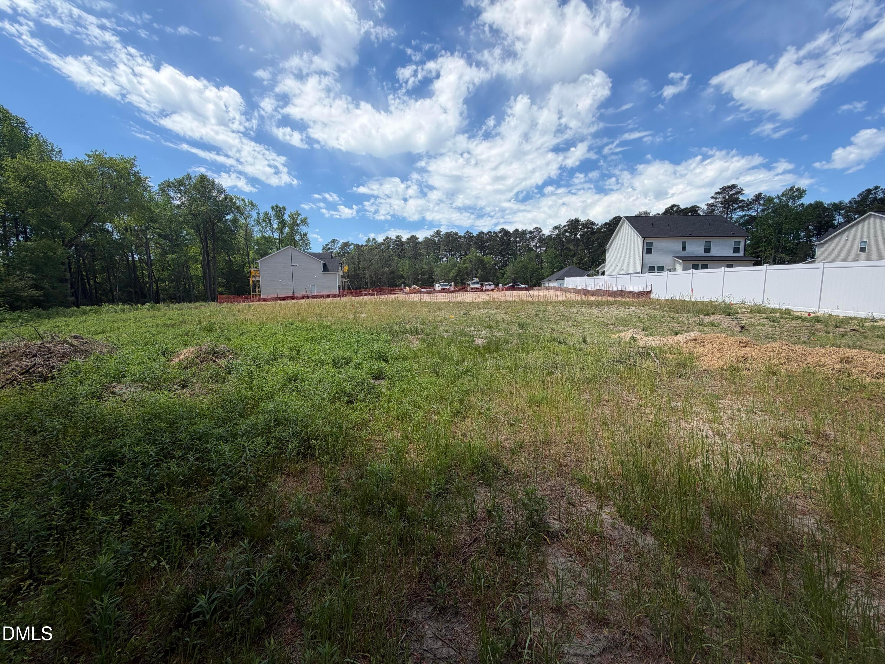 Framed two-story 4-bedroom home with white siding under construction in Wellers Knoll, Lillington, NC by Davidson Homes