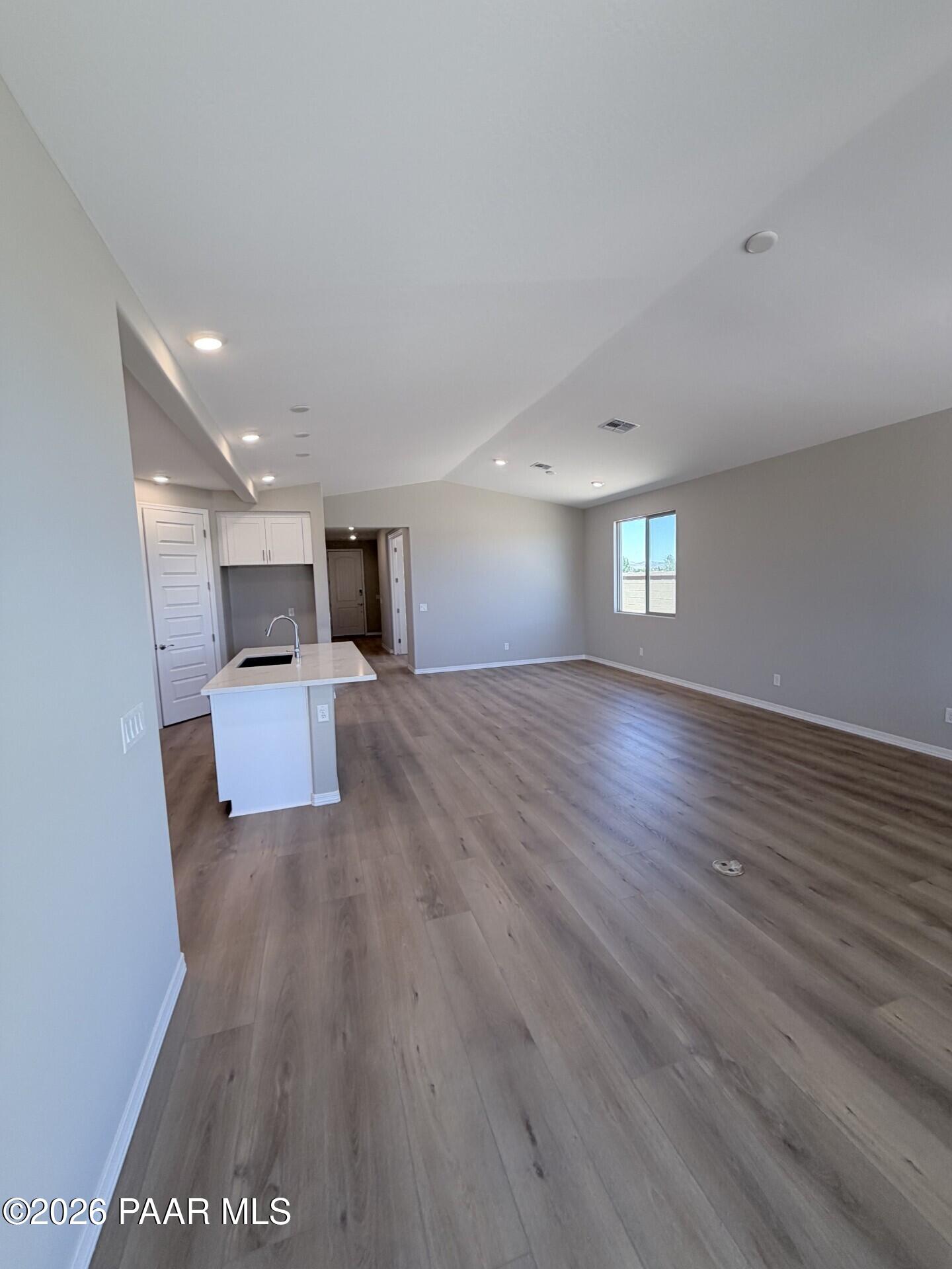 Open-concept floor plan with wood-style flooring in The Frontier A home by Davidson Homes at Pronghorn Ranch, Prescott Valley.