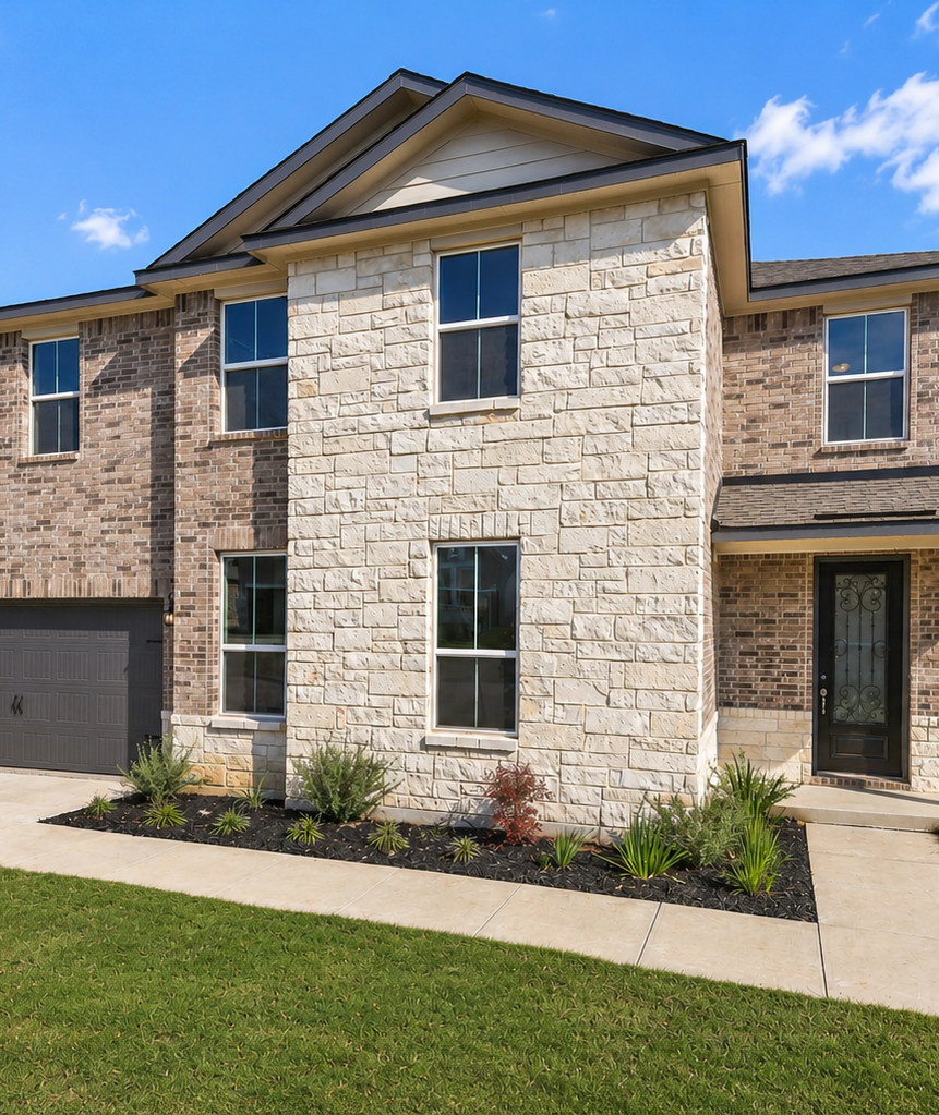 Modern kitchen with quartz island, gray shaker cabinets, and stainless appliances at The Reserve at Potranco Oaks in Castroville, Texas
