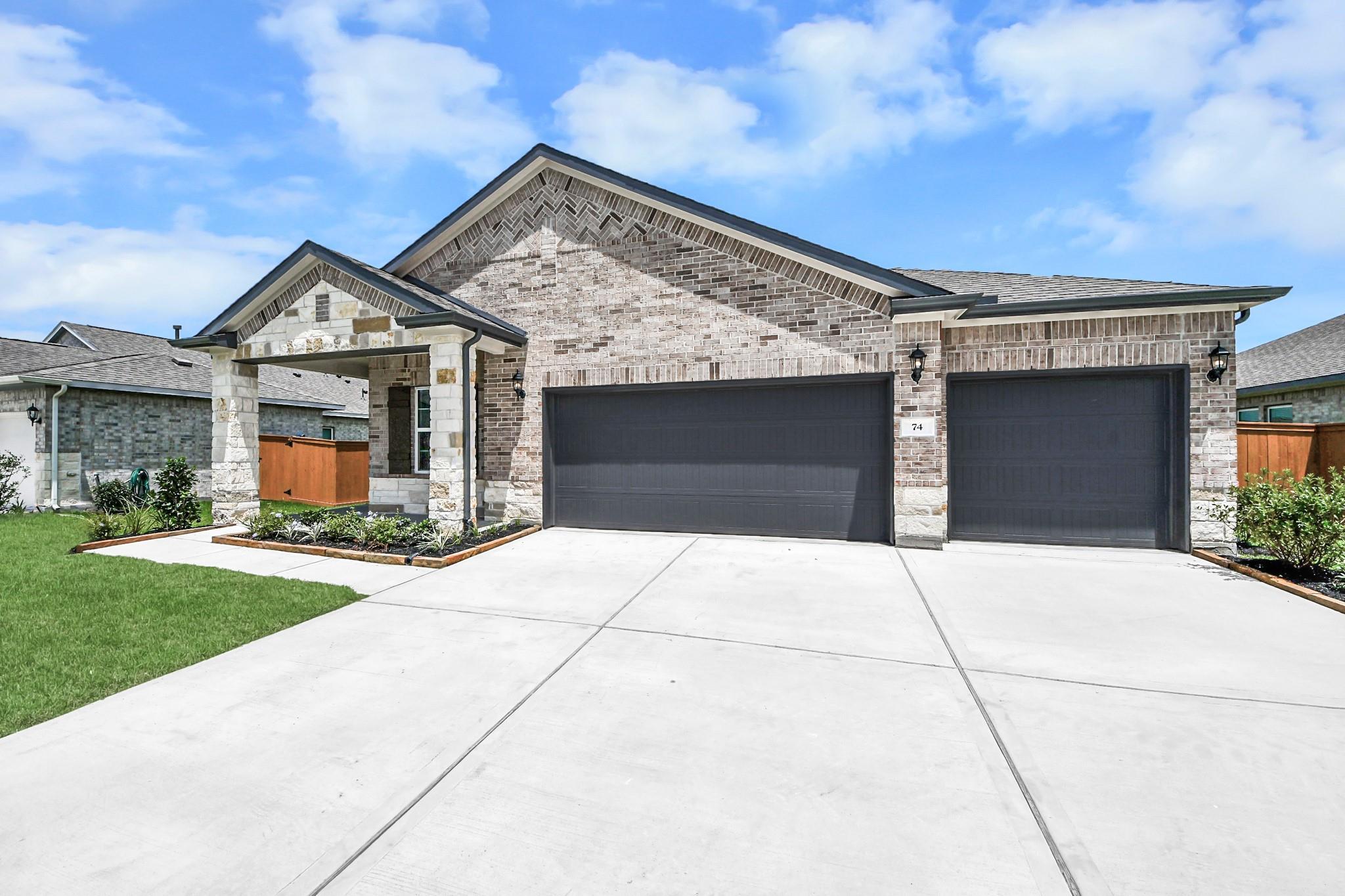 1-story brick home with 3-car garage, Riviera C floor plan by Davidson Homes in River Ranch Meadows, Dayton, Texas.