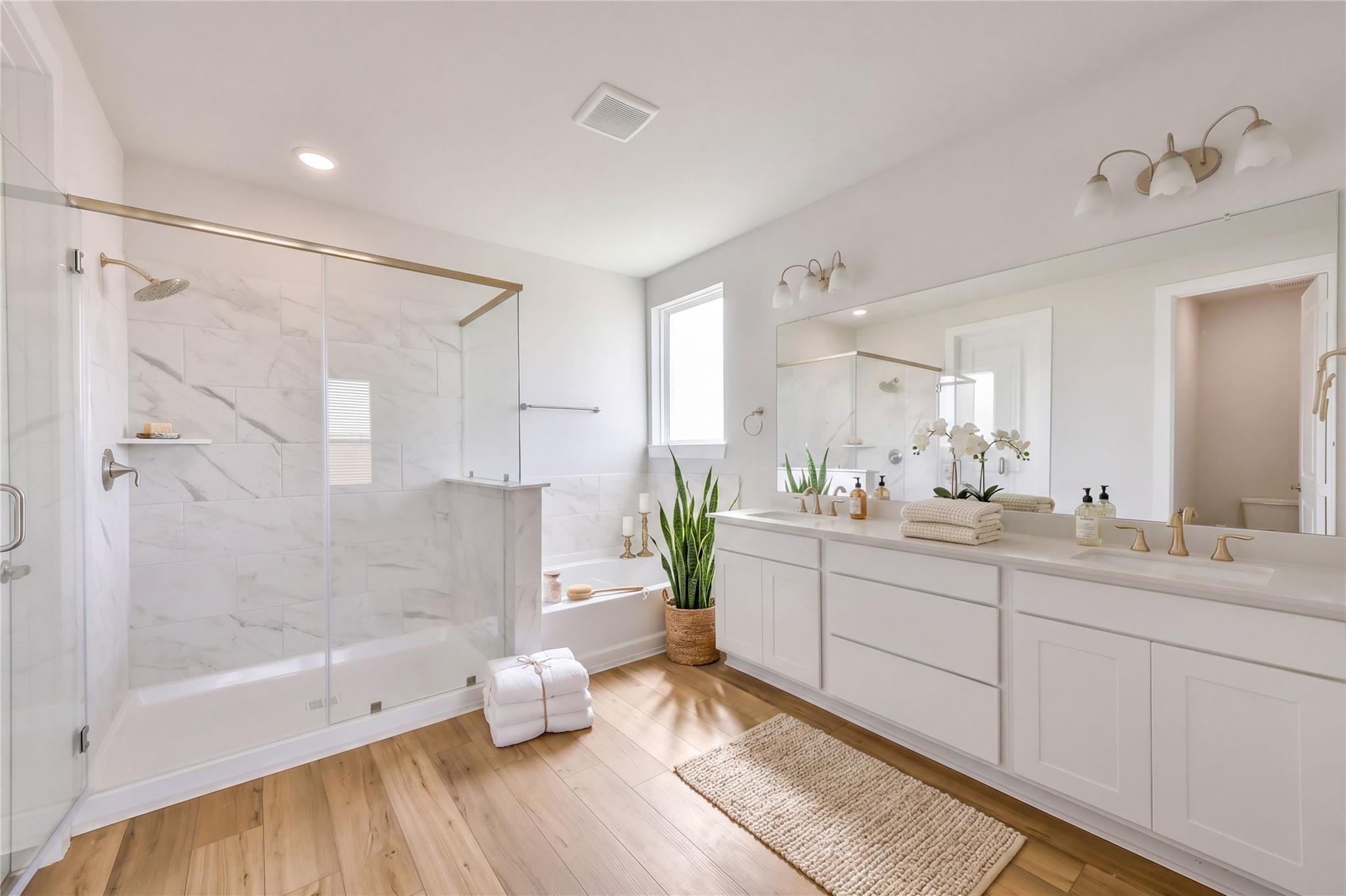 Luxurious master bathroom with marble glass shower, soaking tub, double vanity in Davidson Homes The Victoria A, Lago Mar, Texas City