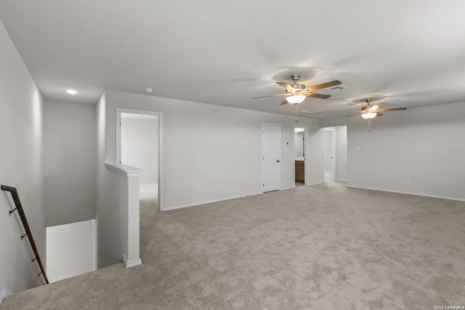 Spacious upstairs game room with ceiling fans in Davidson Homes The San Marcos F floor plan, Rayburn Valley, San Antonio.