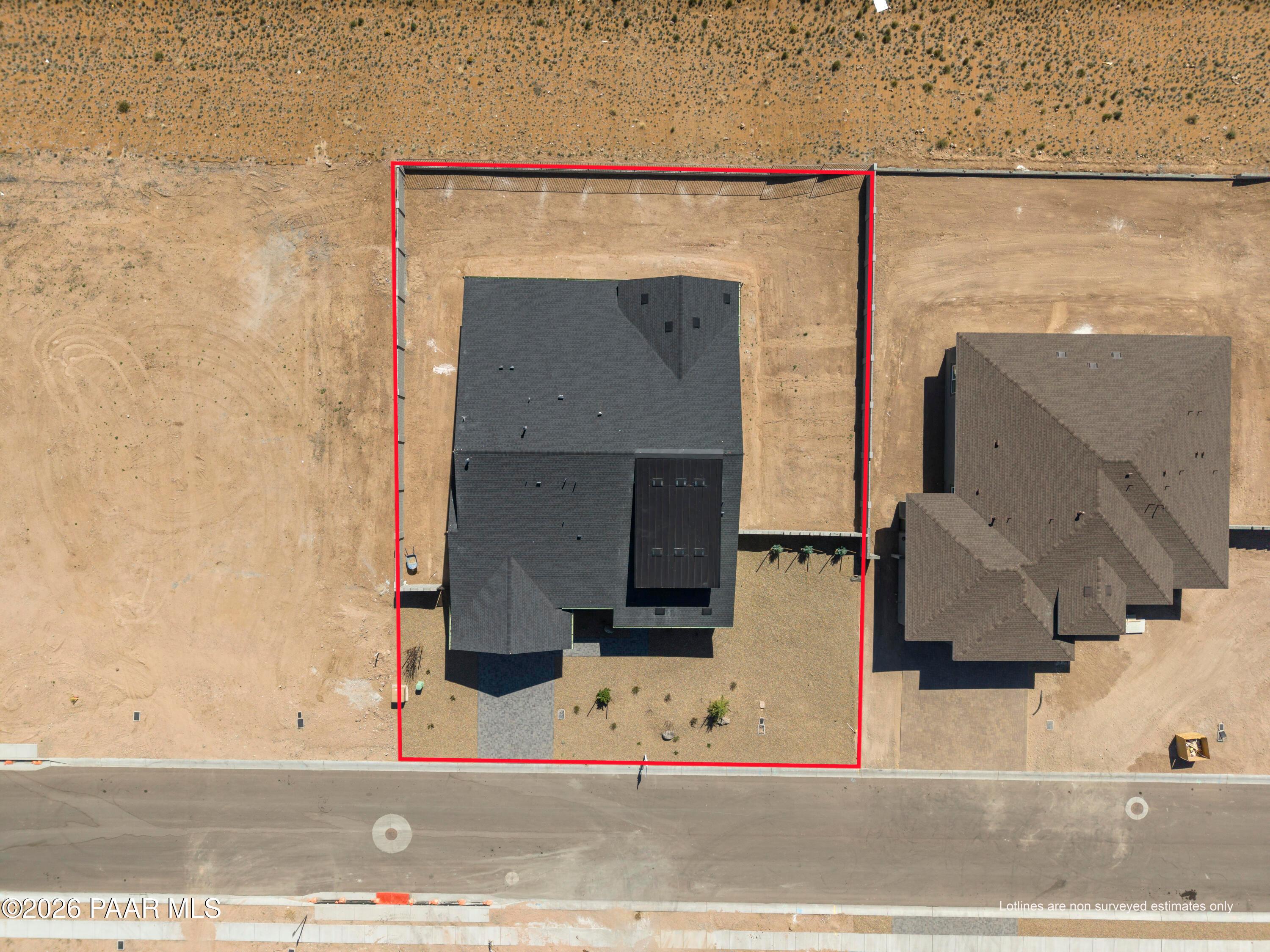 Aerial view of Soleil E single-story home with dark roof, solar panels, and 3-car garage in Hidden Hills, Prescott, Arizona by Davidson Homes