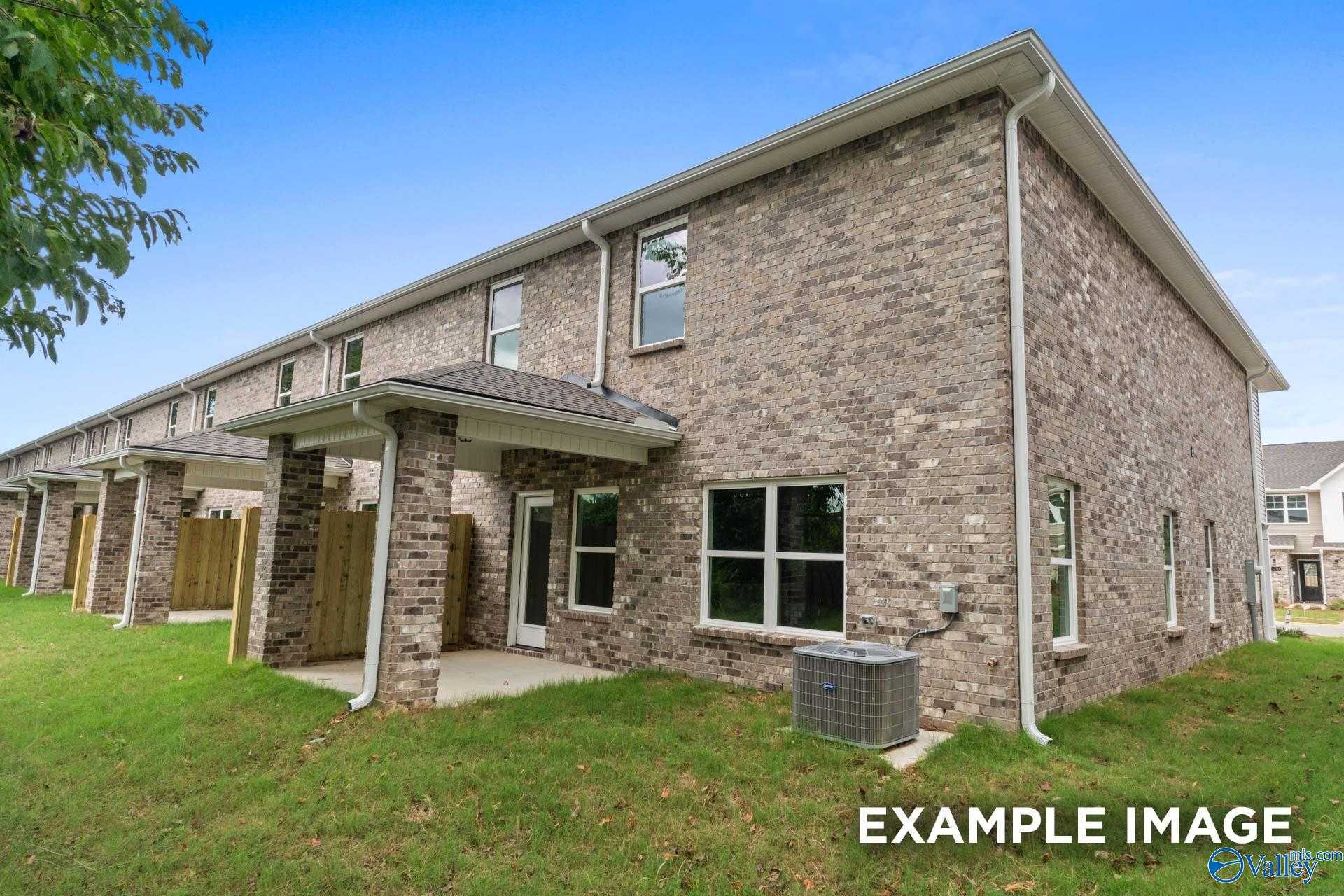 Modern two-story brick home with two-car garage, covered porch, and green lawn in Pavilion, Huntsville, Alabama - Davidson Homes The Camden