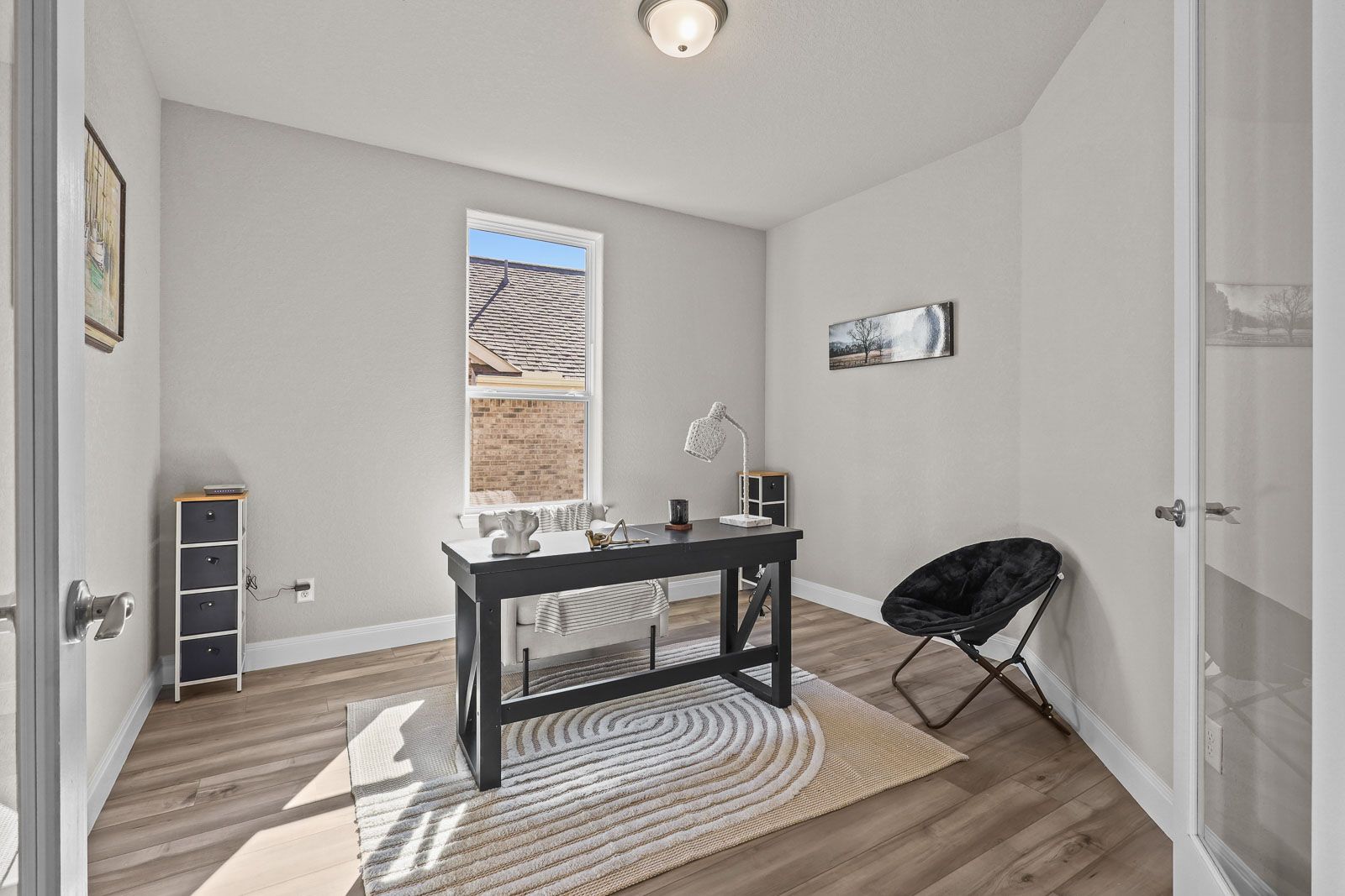 Bright home office in The Jennings G featuring a modern desk, sleek flooring, and natural light in Castroville, Texas.