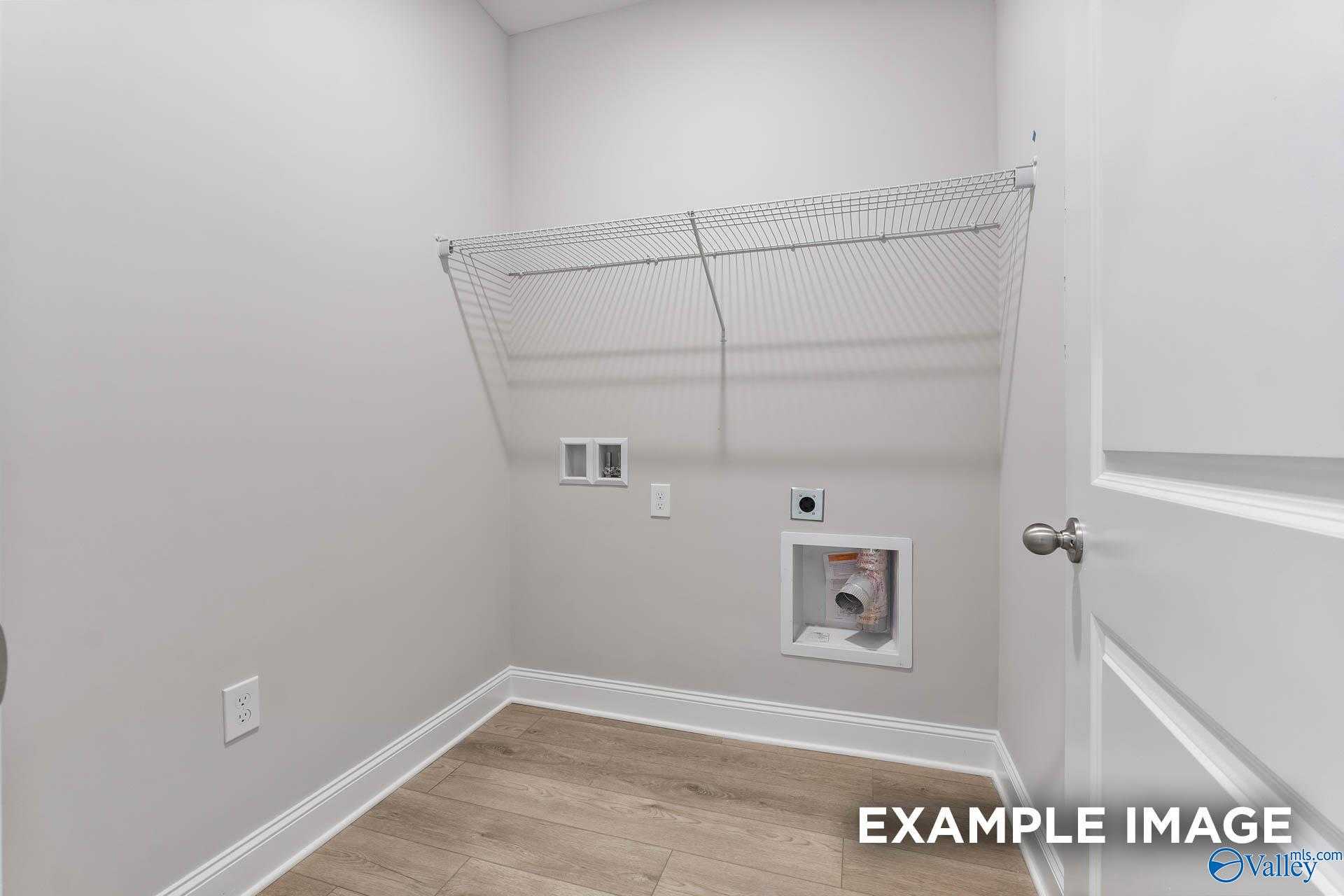 Functional laundry room with wire shelving, washer-dryer hookups in The Franklin C 3-bedroom home, Davidson Homes, Athens AL