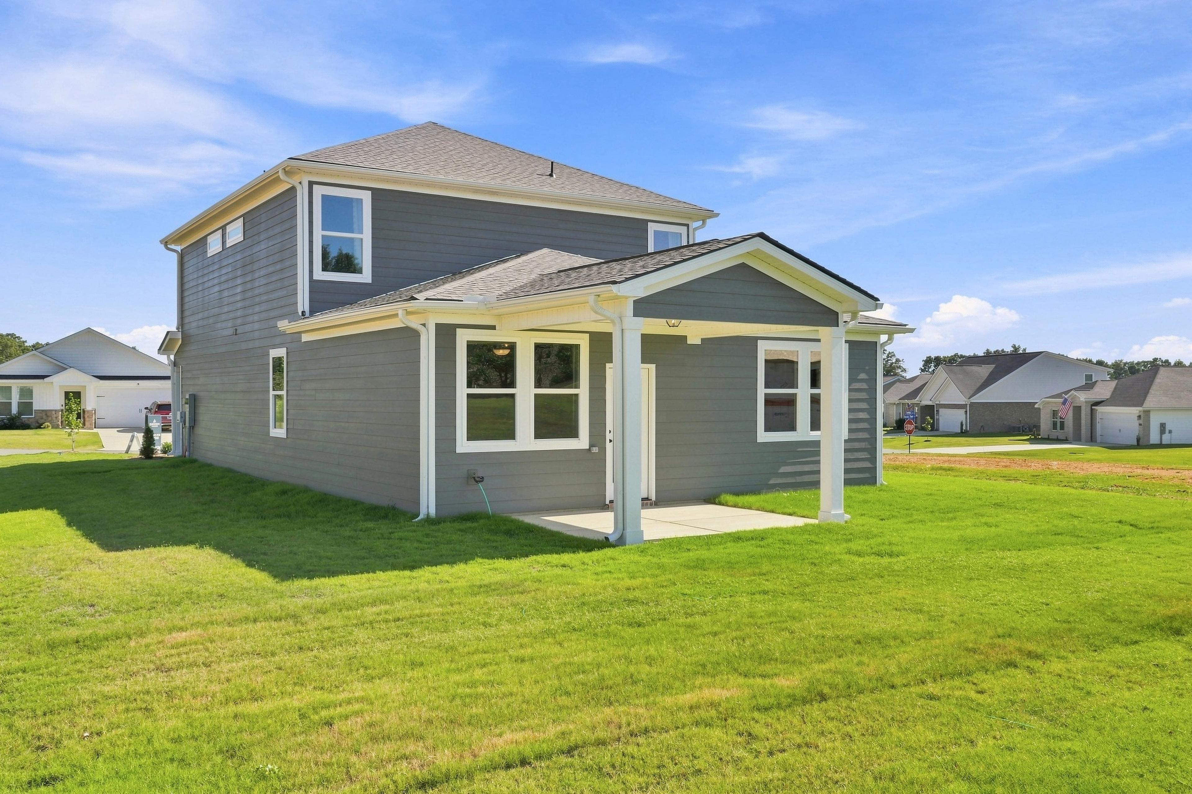 Gray two-story new home with covered porch at Bailey Park by Davidson Homes in Fayetteville, Tennessee