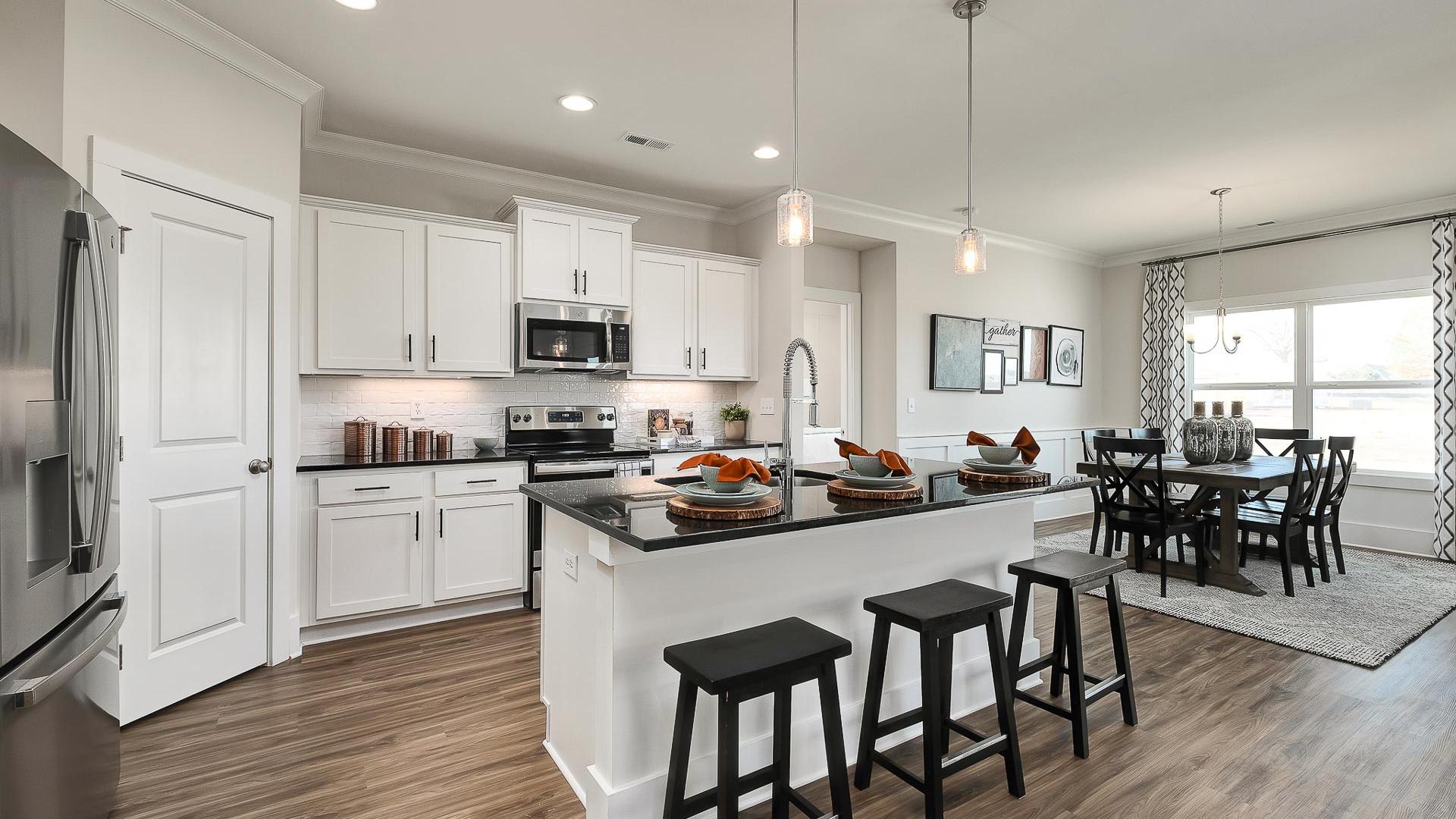 vibrant kitchen with center island and stainless appliances