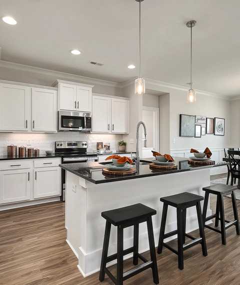 vibrant kitchen with center island and stainless appliances