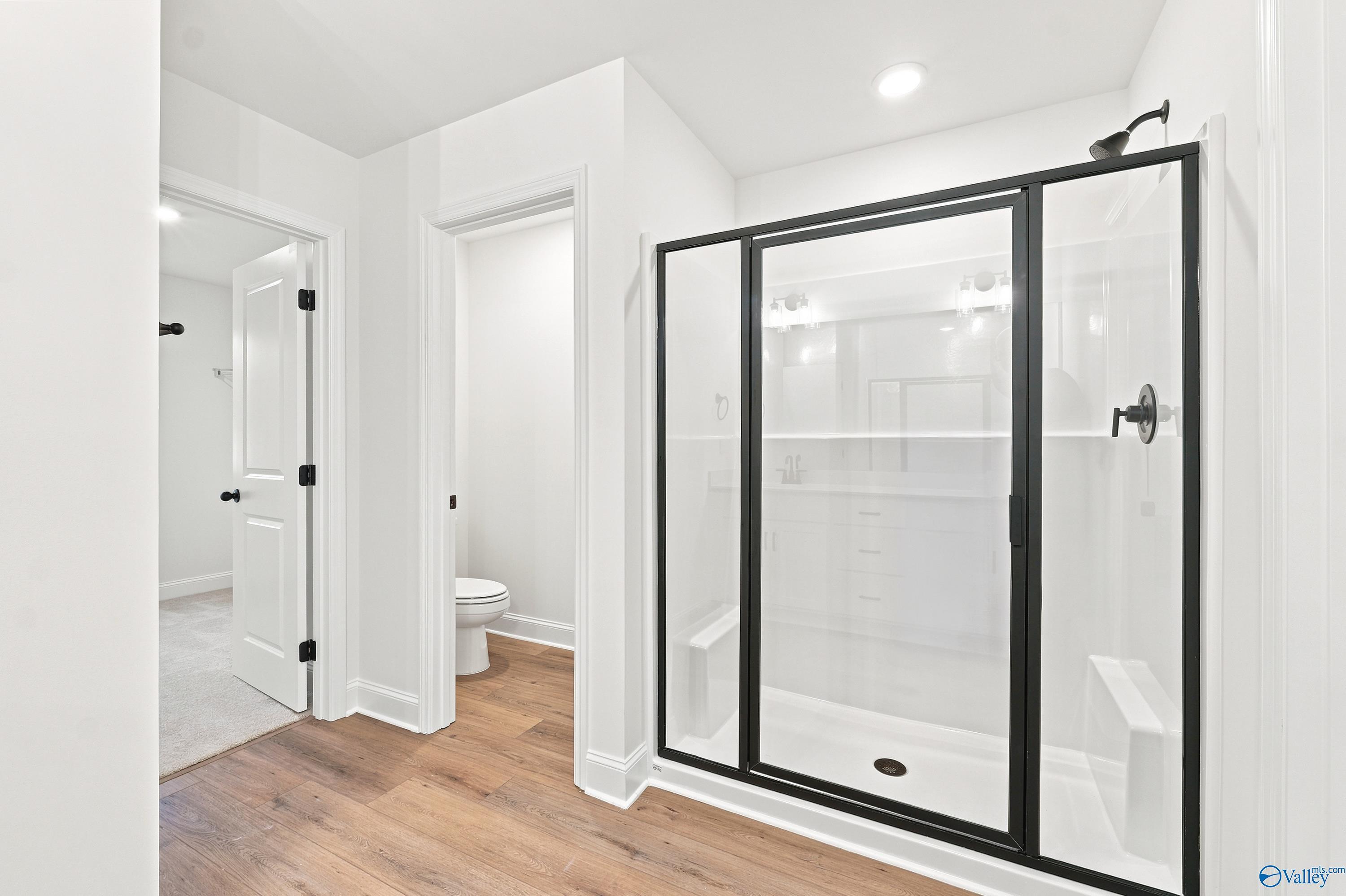 Modern walk-in shower with black frame in The Shelby D floor plan at Noble Ridge, Cullman, Alabama.