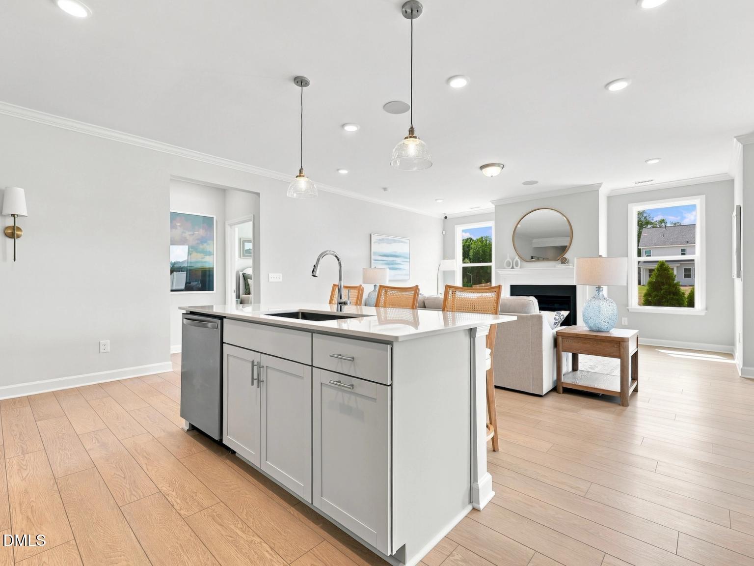 Open-concept kitchen island with quartz countertops in The Daphne C floor plan at Woodland Crossing, Zebulon, North Carolina.