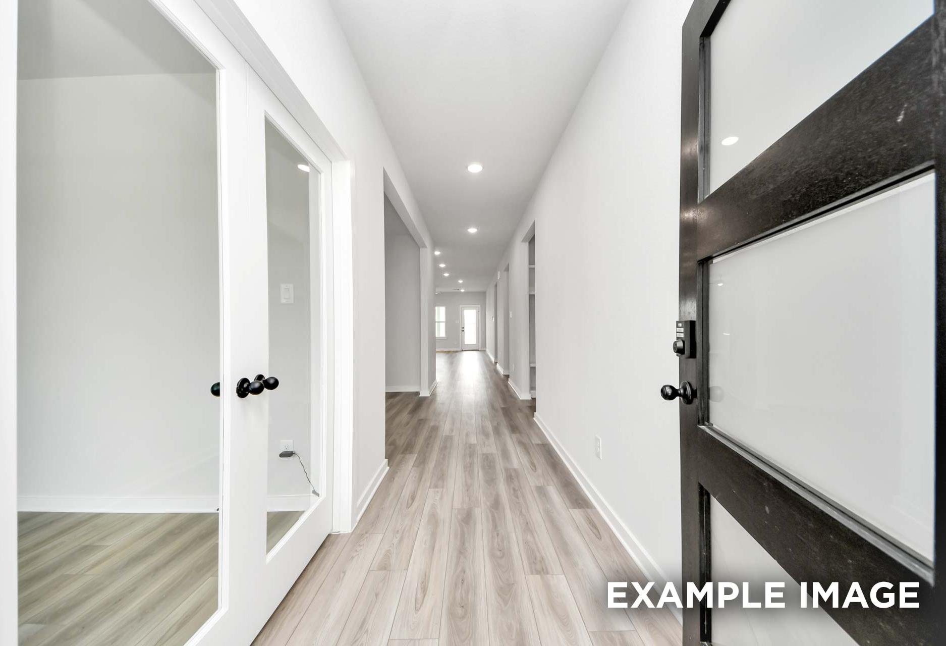 Bright hallway in The Sorrento home design featuring modern wood-look flooring and glass-paneled interior doors.