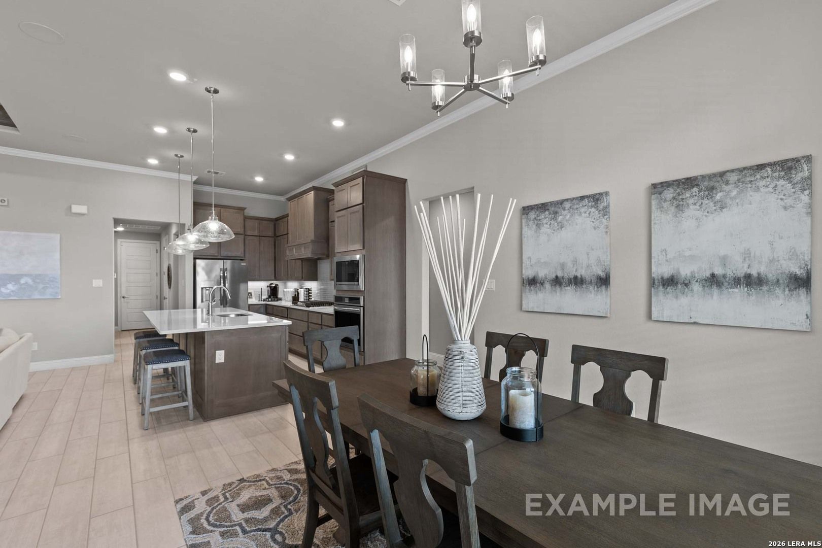 Open-concept kitchen and dining area with modern dark cabinetry in The Garner C plan at The Reserve at Potranco Oaks.