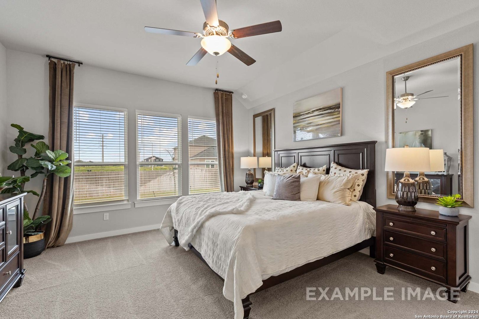 Elegant master bedroom with king bed, ceiling fan, large windows, and modern decor in Davidson Homes The Collin A, Seguin, Texas