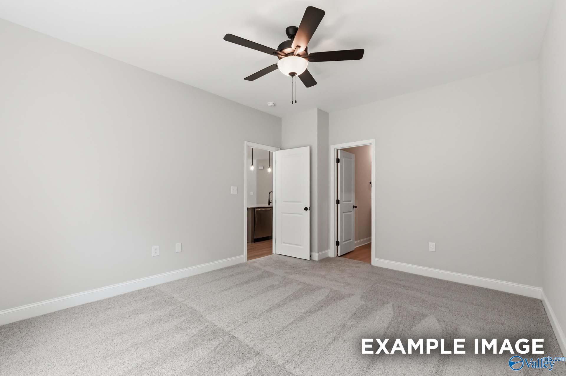Bright bedroom with ceiling fan and plush carpet in The Franklin C floor plan by Davidson Homes in The Meadows, Alabama.