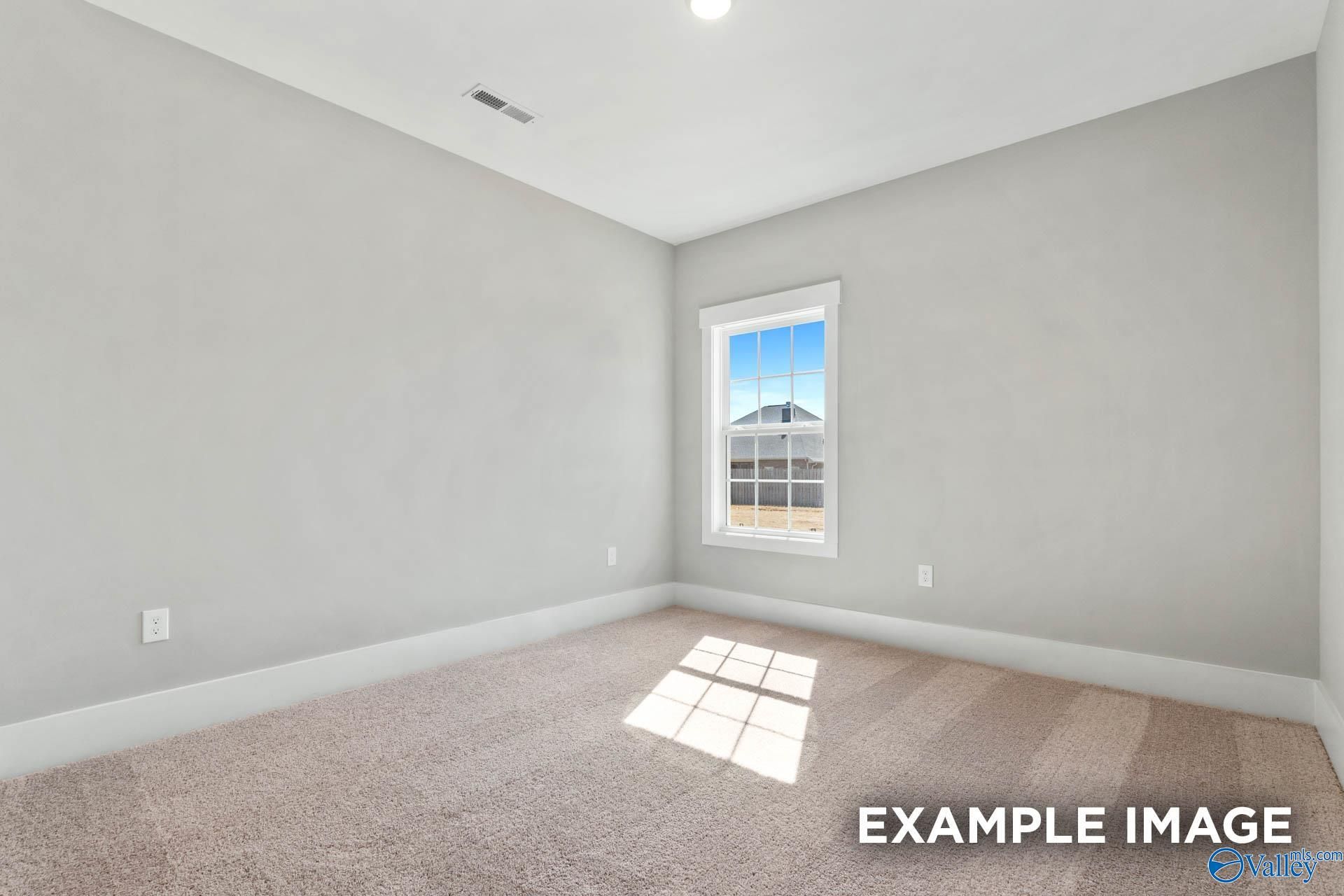 Bright secondary bedroom with neutral carpet and paint in The Finleigh floor plan at Briercreek, Meridianville, Alabama.