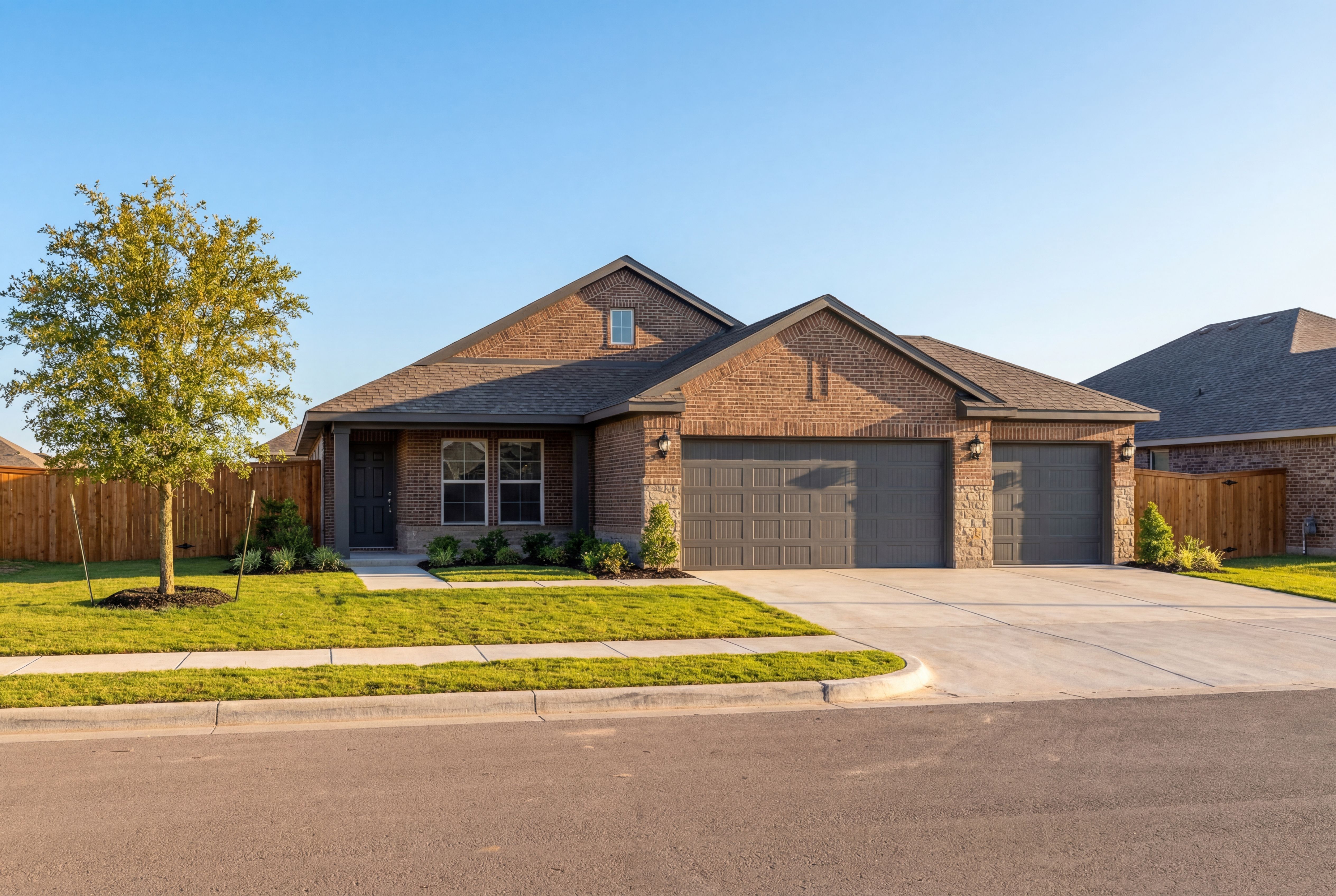Modern brick single-story home, The Costa C with 3-car garage, landscaped yard, Dayton Texas
