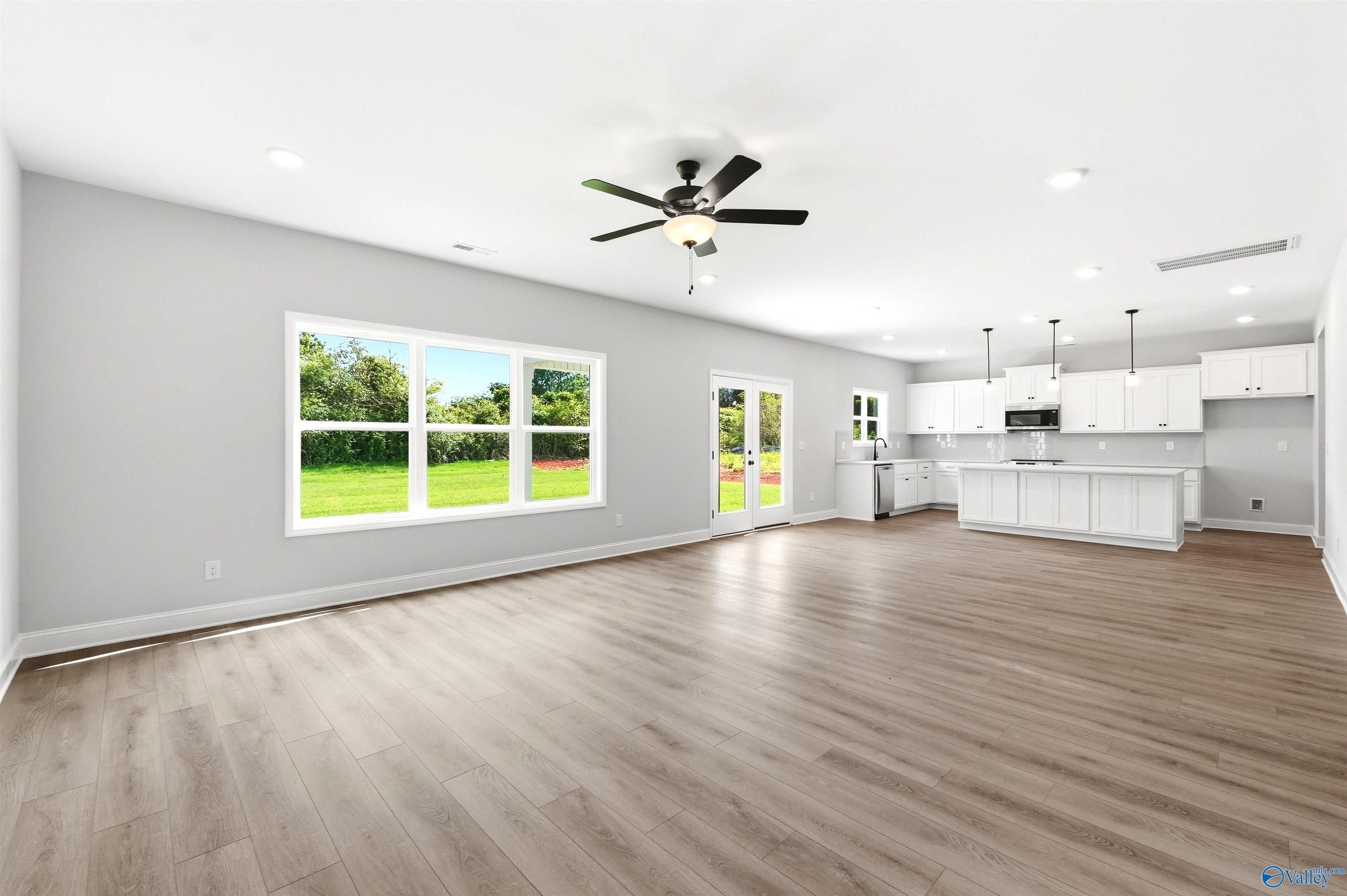 Open-concept living room and kitchen in The Chelsea D floor plan at Berry Cove, New Market, Alabama.