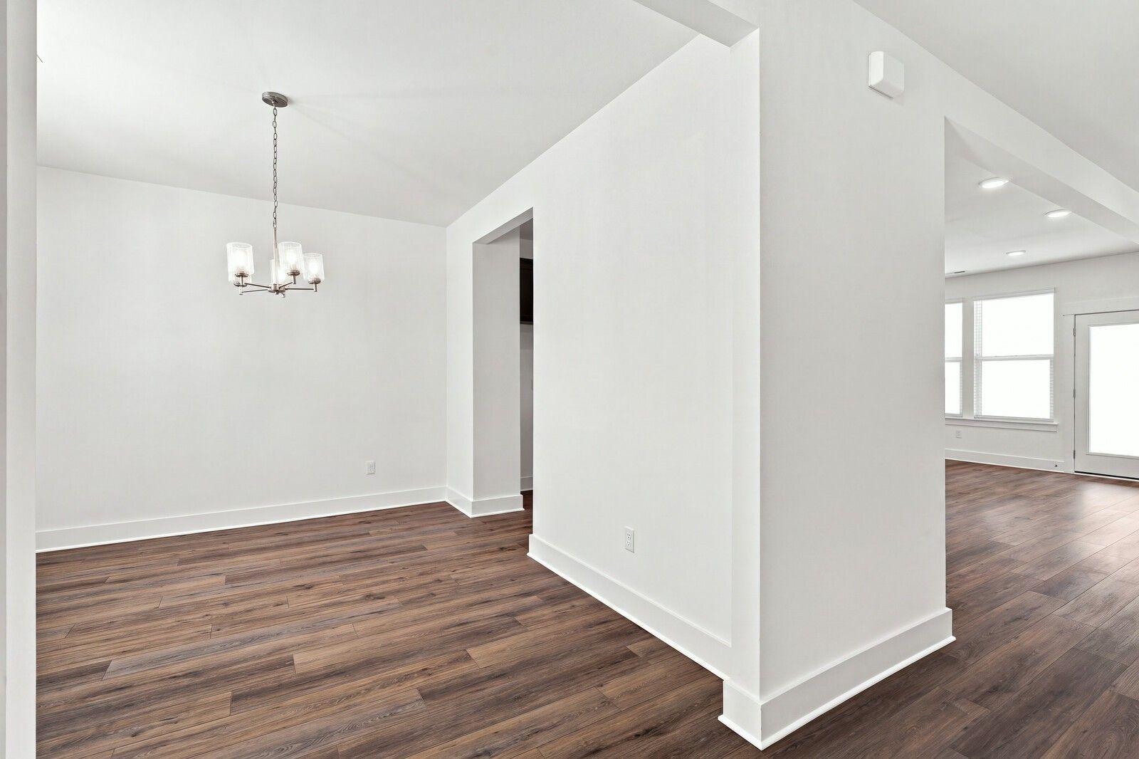 Bright open-concept dining area with chandelier and luxury vinyl plank flooring in Davidson Homes Willow C plan, Gallatin, TN