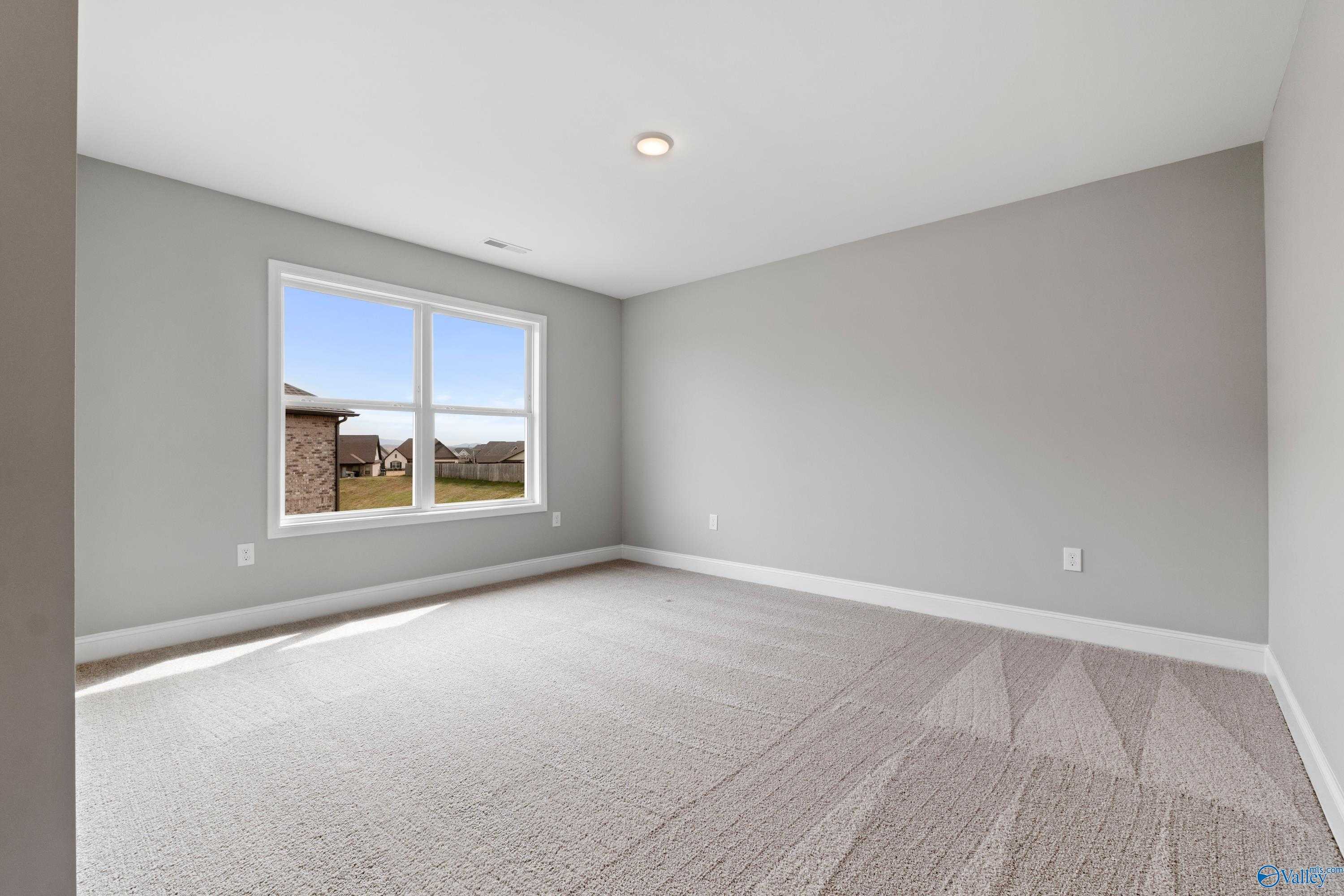 Bright secondary bedroom with large window and scenic view in Davidson Homes The Aiken, Meridianville, Alabama