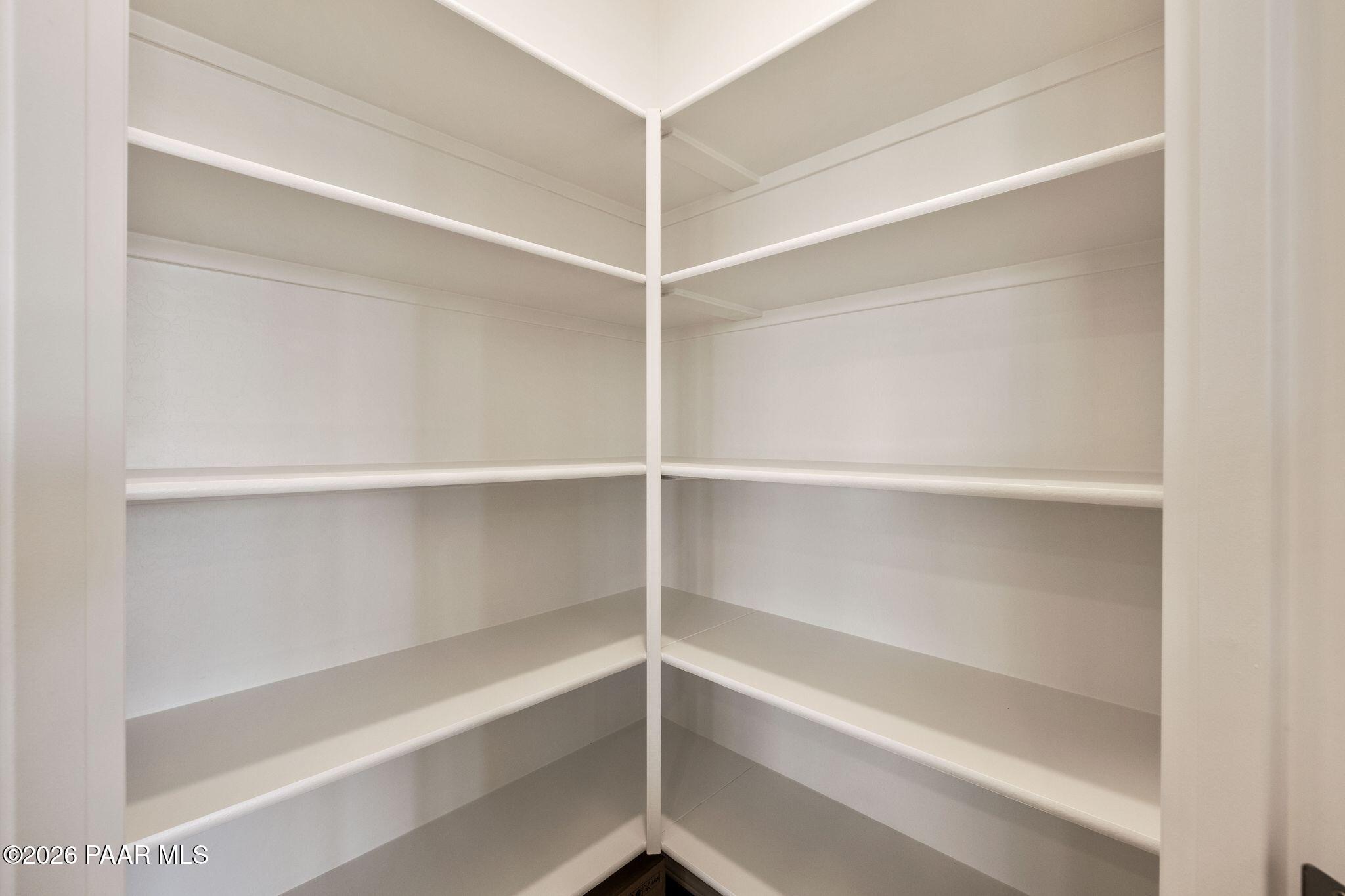 Spacious corner pantry with open white shelves in Davidson Homes The Frontier A, Prescott Valley, Arizona