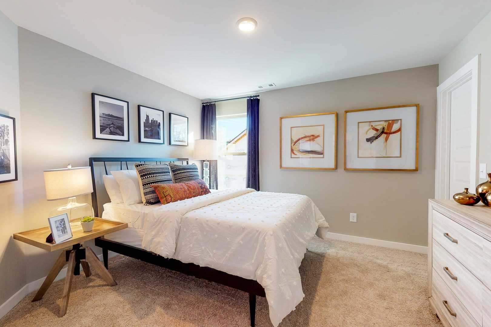Cozy bedroom interior at Liberty Creek in Gallatin TN with queen bed, gray walls, abstract artwork, and neutral decor