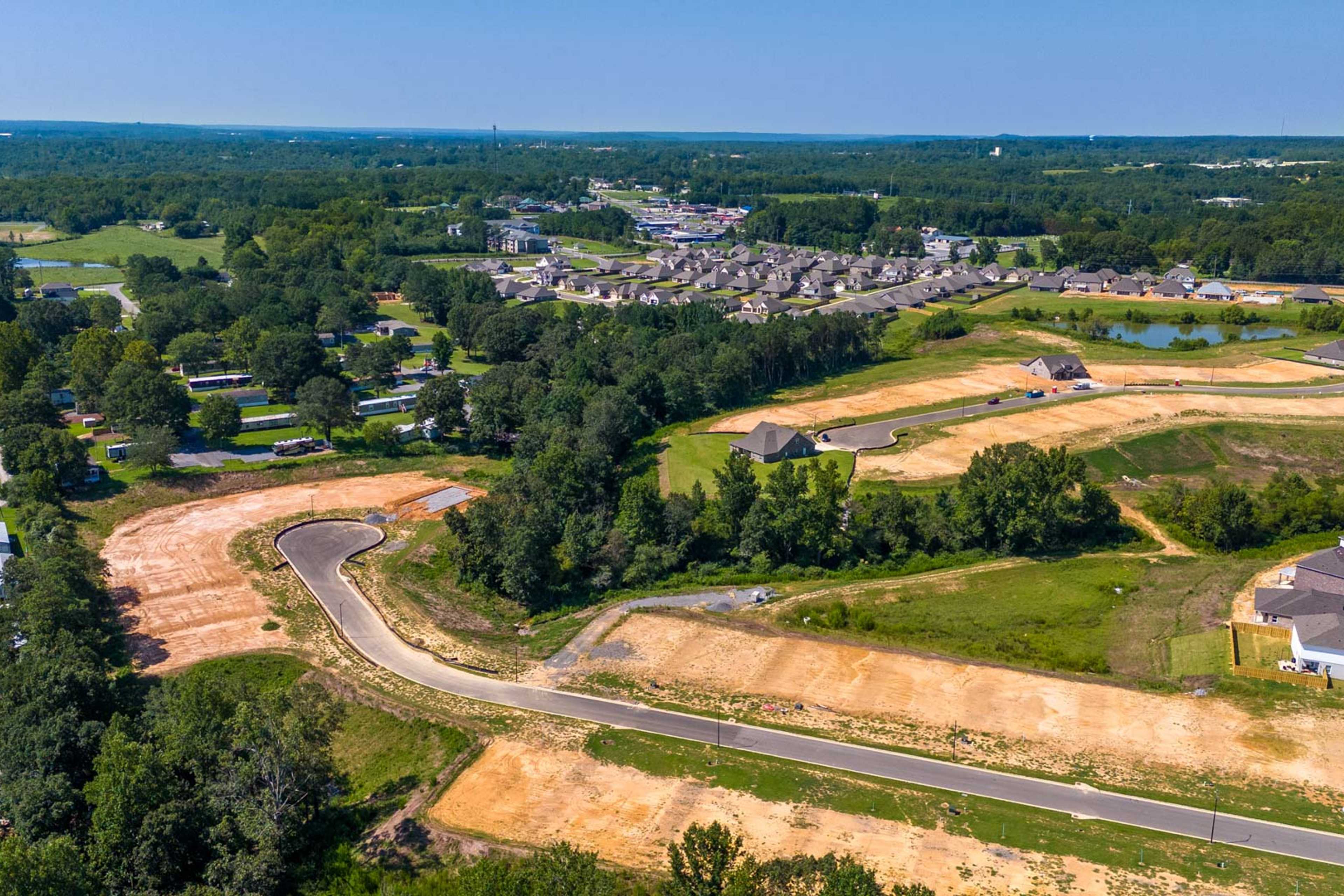 Aerial view of new home construction at The Reserve at North Ridge in Cullman Alabama with developing streets and wooded lots