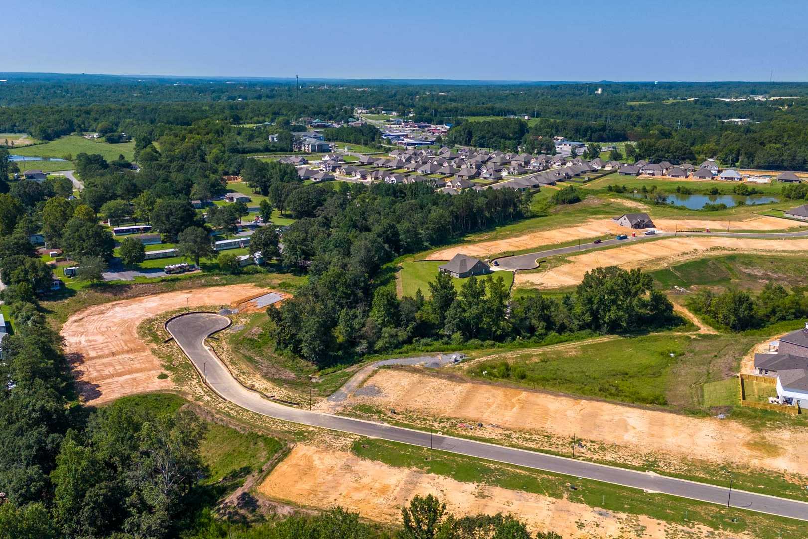 Aerial view of new home construction at The Reserve at North Ridge in Cullman Alabama with developing streets and wooded lots