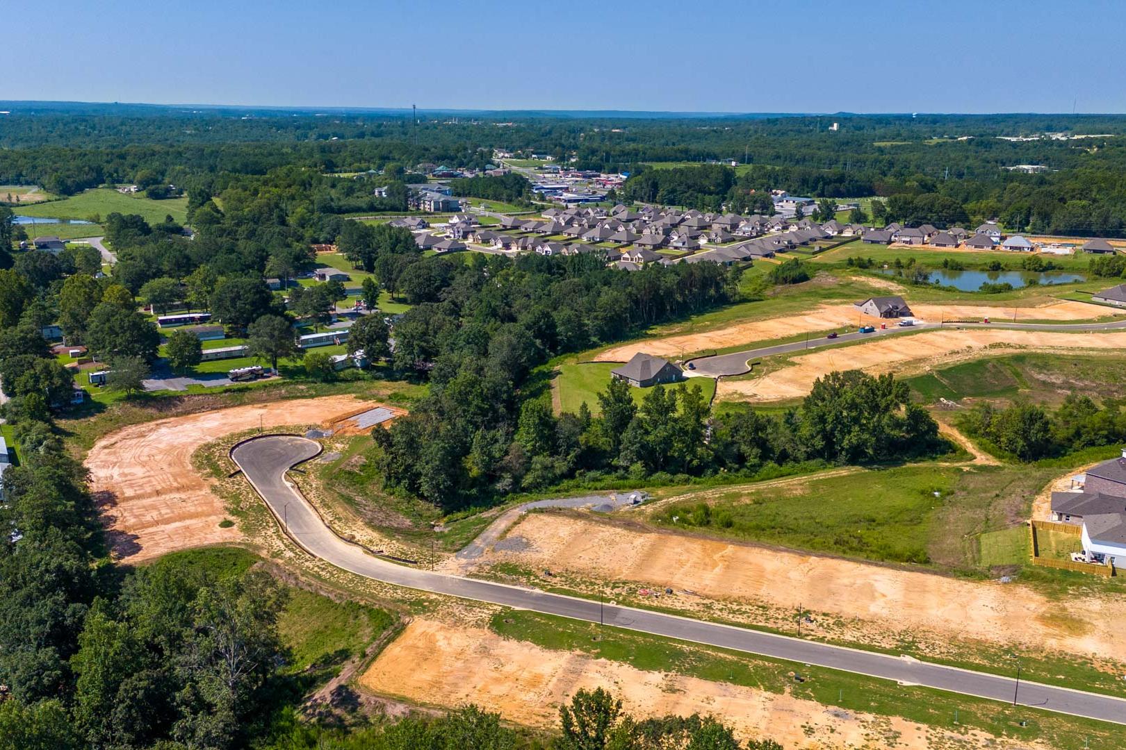 Aerial view of new home construction at The Reserve at North Ridge in Cullman Alabama with developing streets and wooded lots