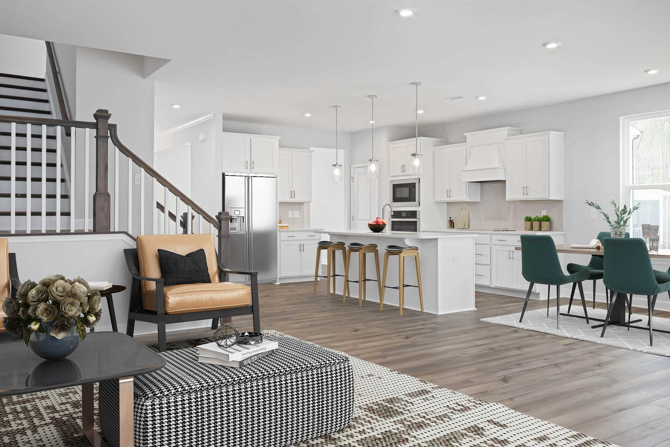 Open-concept kitchen and living area in Stagecoach Corner Mebane NC with white cabinets, hardwood floors, island bar and modern seating