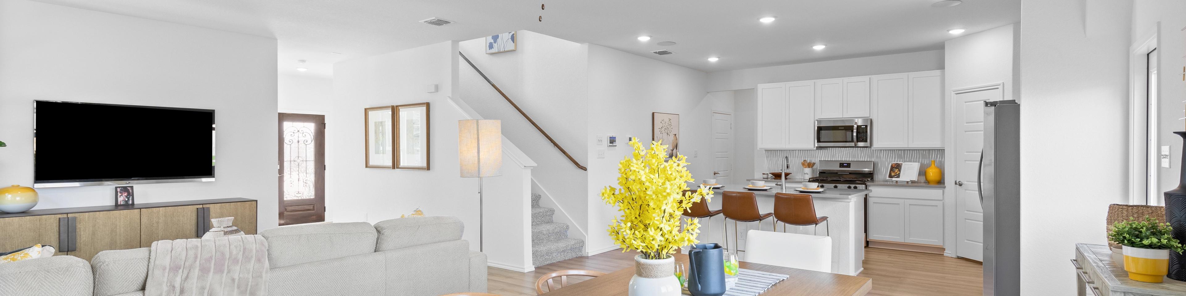 Open-concept living and dining area at Horizon Pointe in Converse TX with hardwood floors, white kitchen cabinets, and ceiling fan