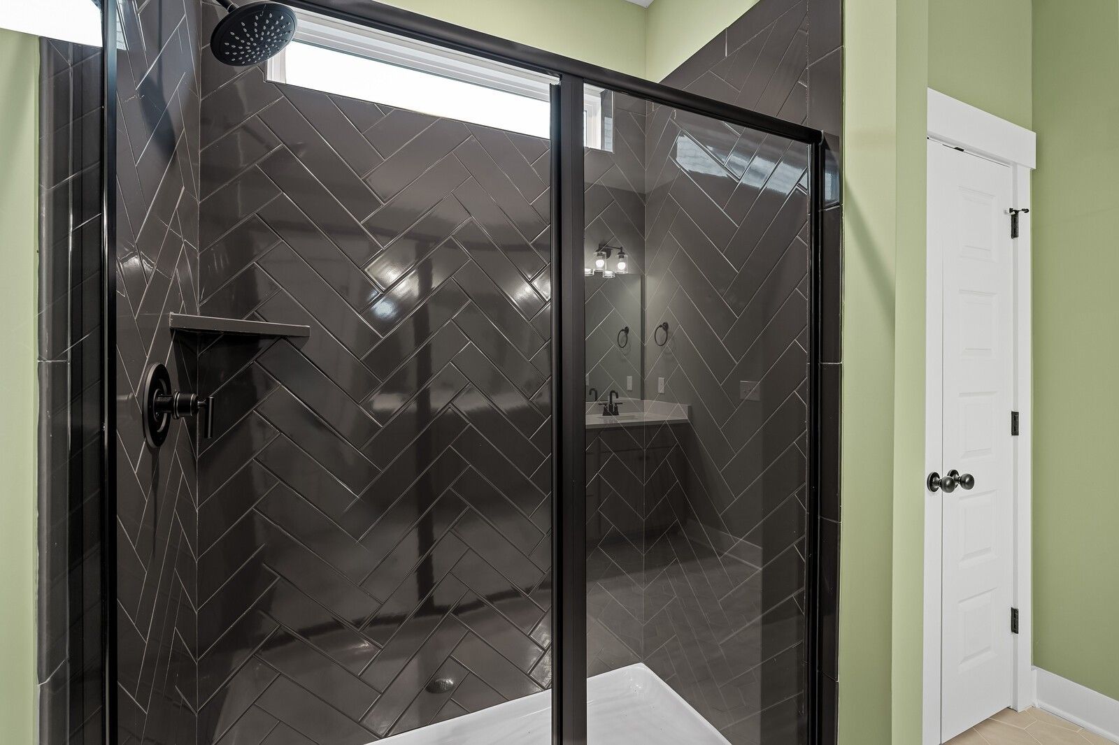 Luxurious master bathroom with black subway tile walk-in shower and glass enclosure in Davidson Homes The Ridgeport, Gallatin, TN