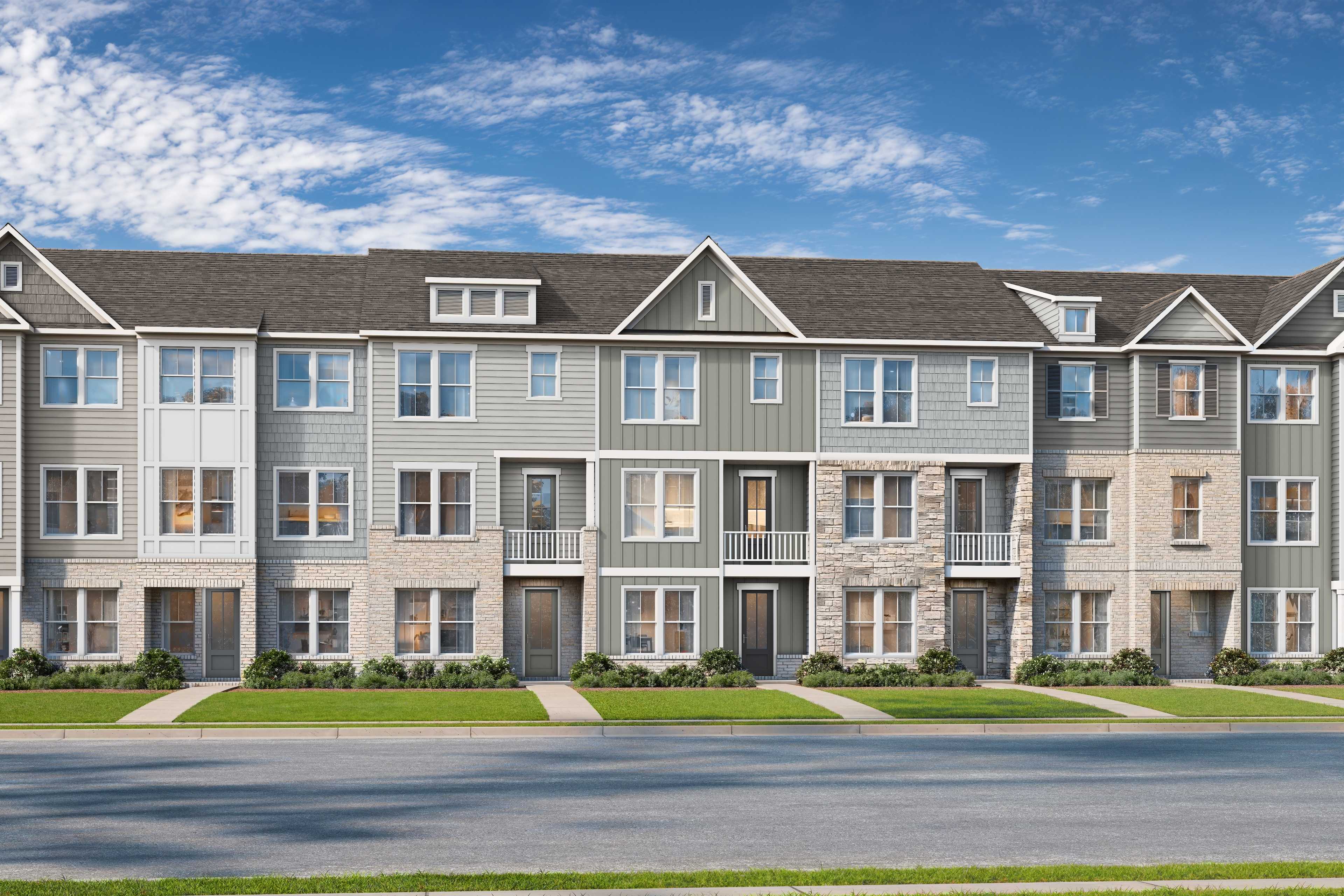 Row of modern gray townhomes at Grafton Trace in Woodstock, Georgia with pitched roofs, large windows and green lawns