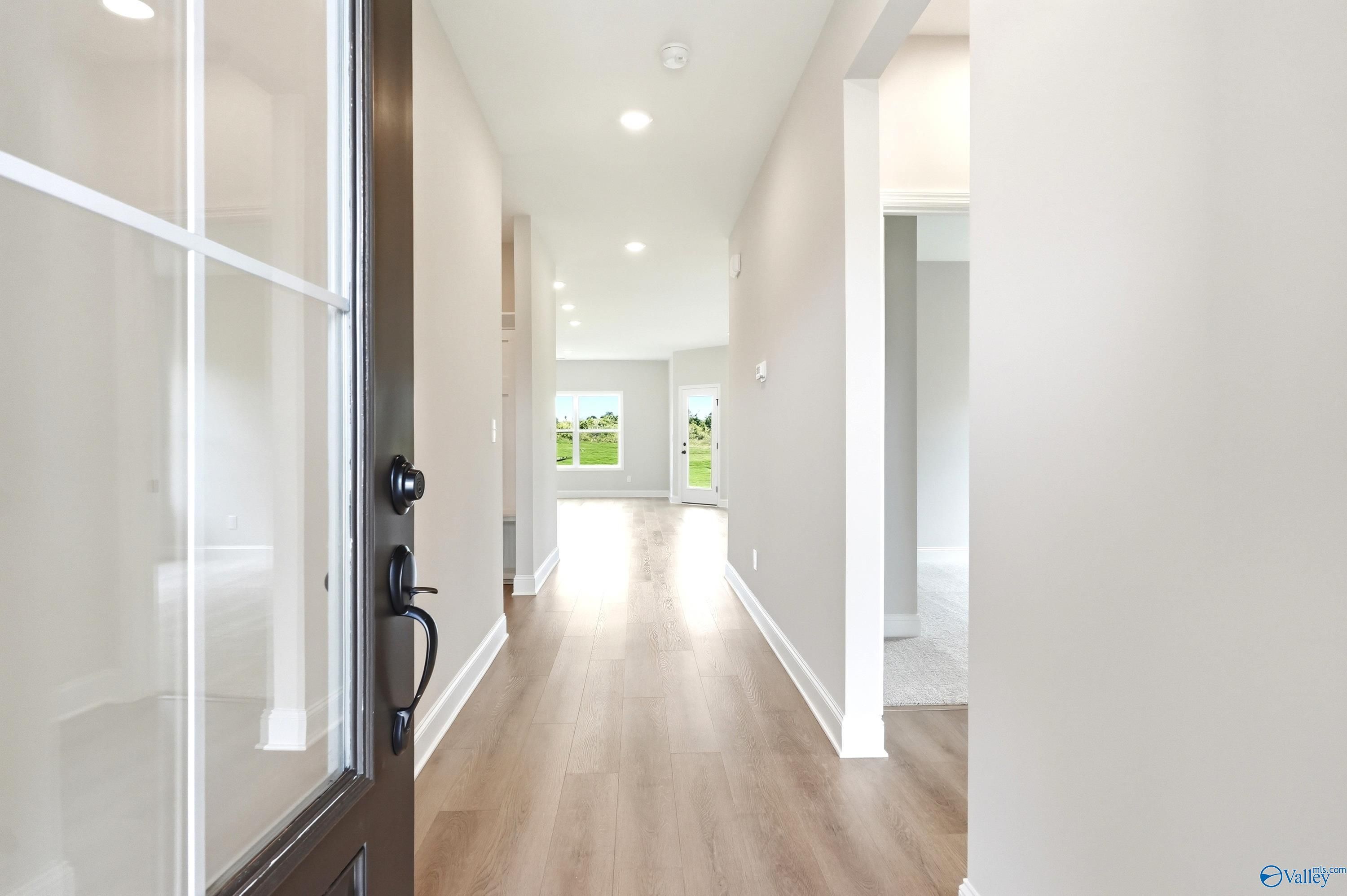 Bright foyer entrance with luxury vinyl plank flooring in The Franklin floor plan at Ricketts Farm, Athens, Alabama.