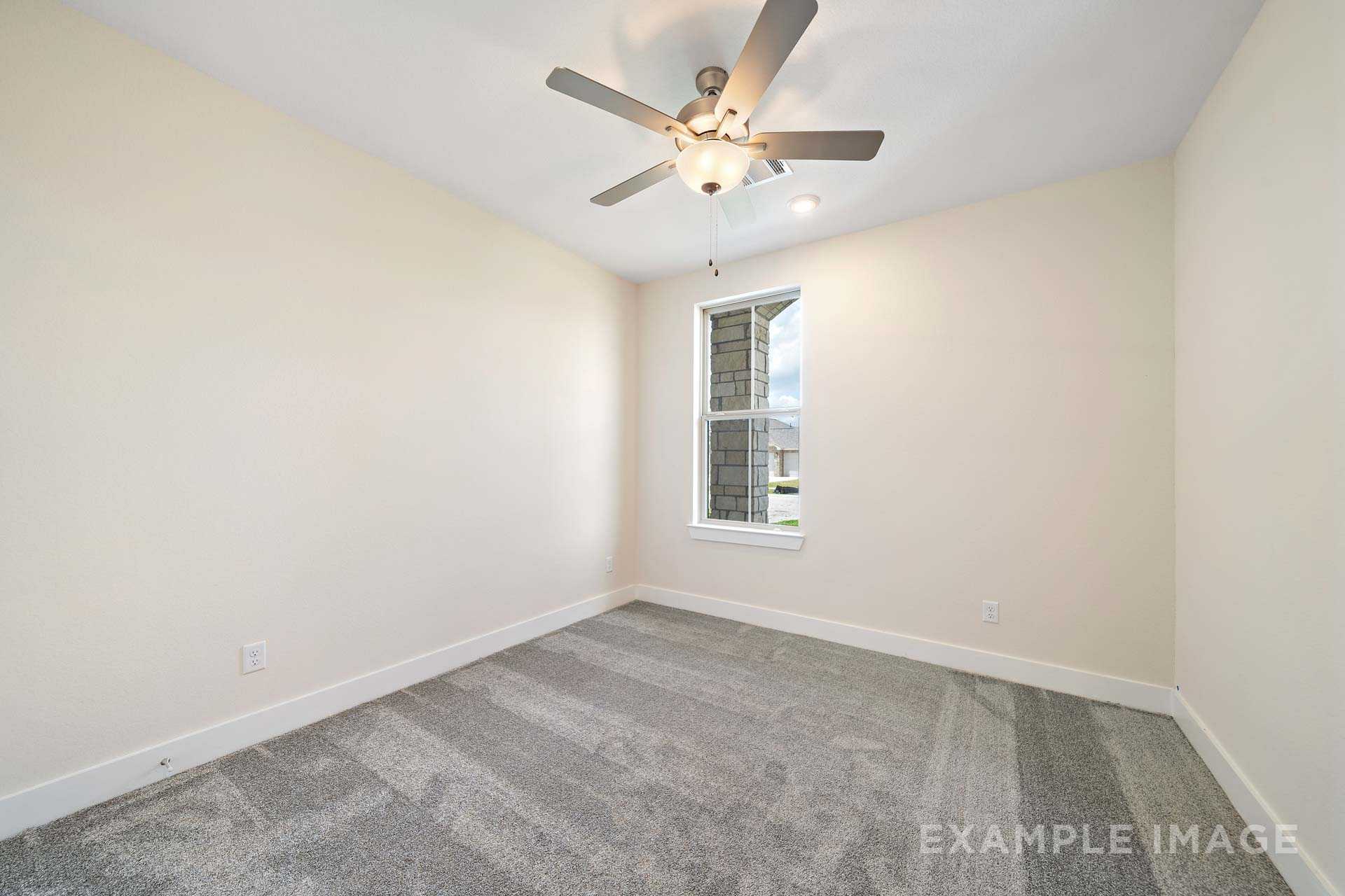 Spacious secondary bedroom in The Diana C by Davidson Homes featuring beige walls, ceiling fan, large window, and gray carpet