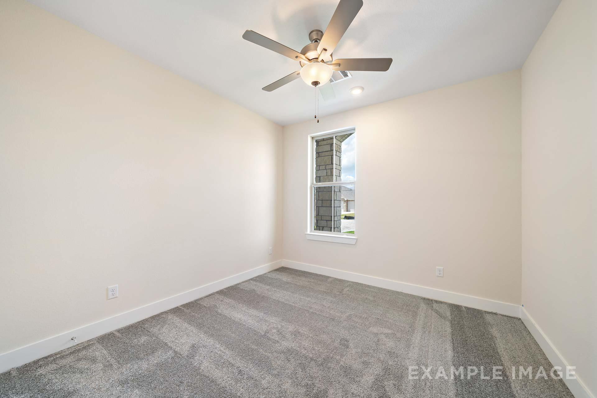 Spacious secondary bedroom in The Diana C by Davidson Homes featuring beige walls, ceiling fan, large window, and gray carpet