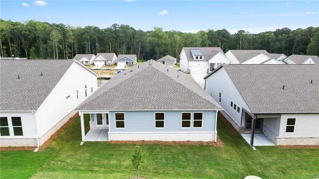 Aerial view of The Daphne C 3-bedroom single-story home by Davidson Homes in Kelly Preserve, Loganville, Georgia, with white siding, gray roof, porches, and green lawns