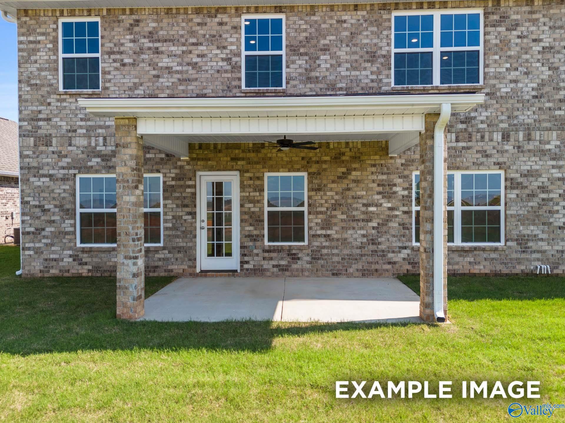 Covered back patio with ceiling fan, French doors, and brick exterior in Davidson Homes Madison A, Kendall Downs, Toney, Alabama