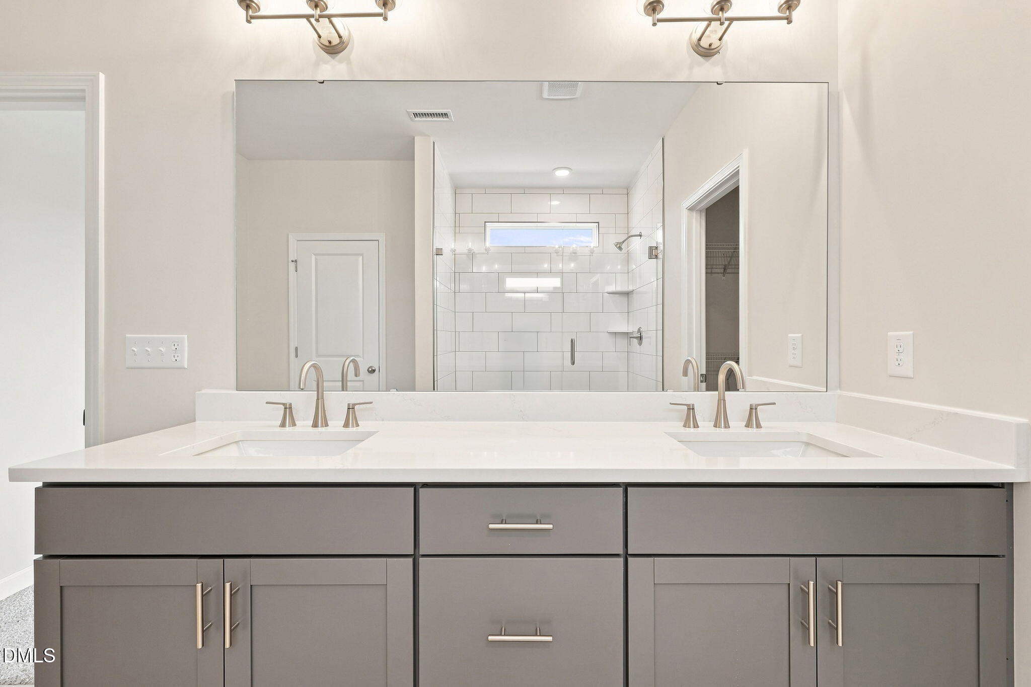 Double vanity with quartz countertop and gray cabinets in The Magnolia B floor plan at Retreat at North Main, Lillington, NC.