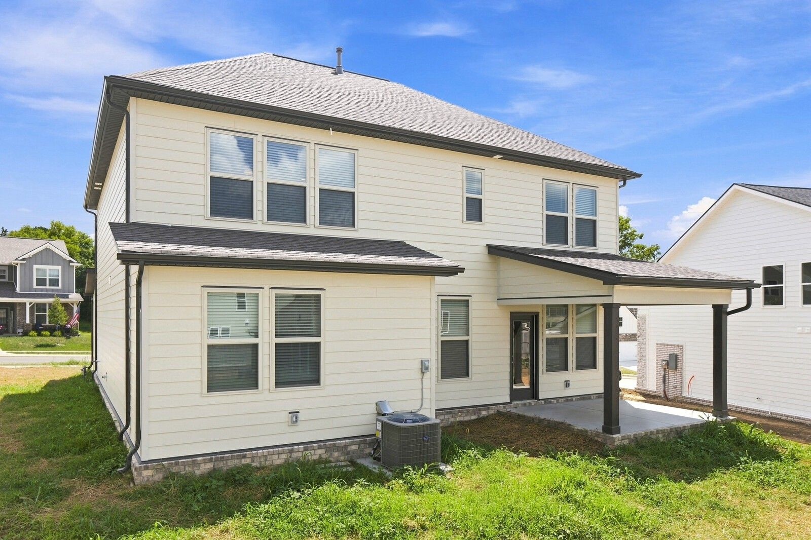 Rear exterior of 2-story Davidson Homes The Willow C with covered patio in Woods Crossing, Gallatin, Tennessee