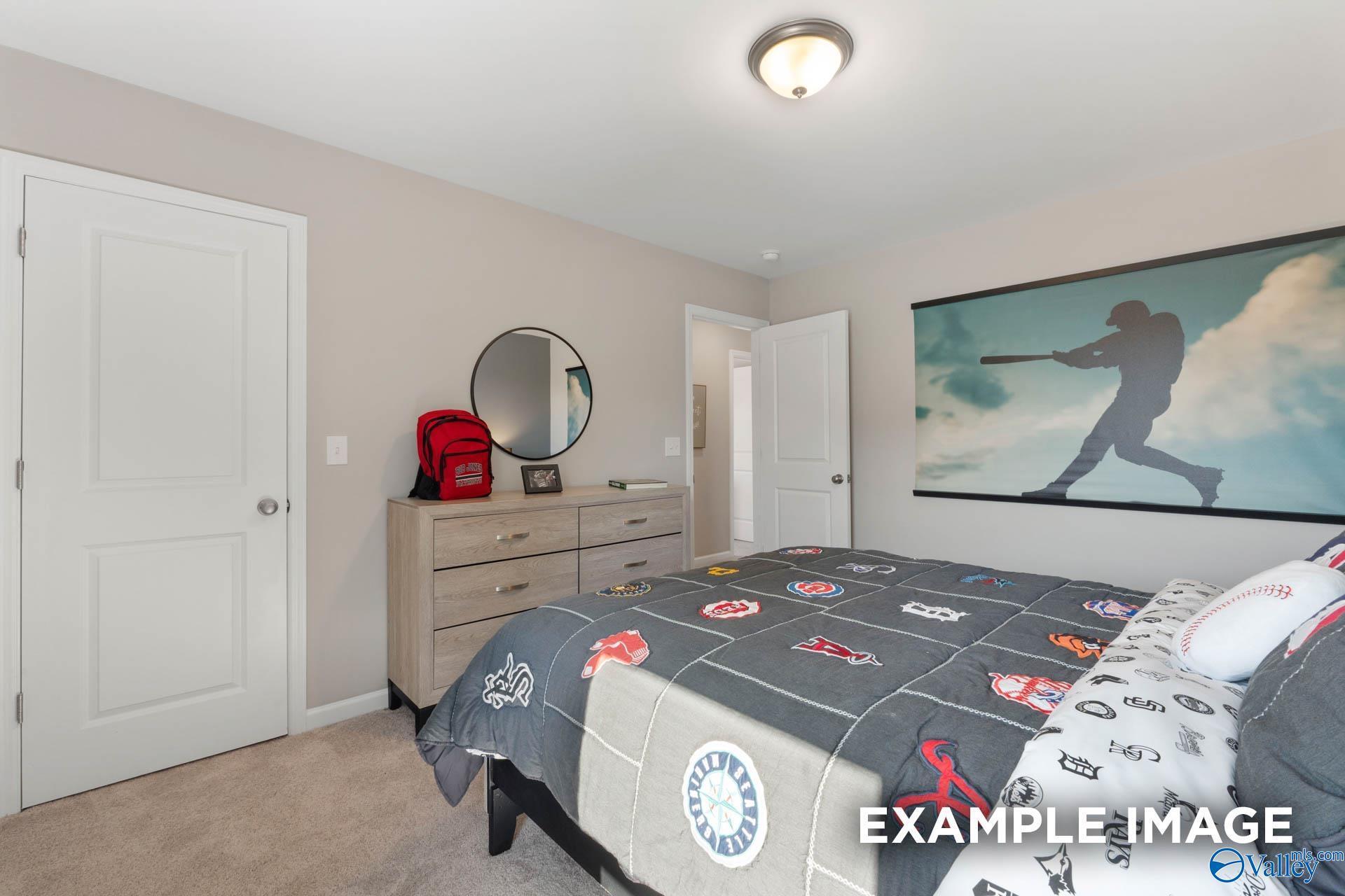 Baseball-themed boy's bedroom with wall mural, twin bed, dresser, and mirror in Davidson Homes The Stella, Madison, Alabama