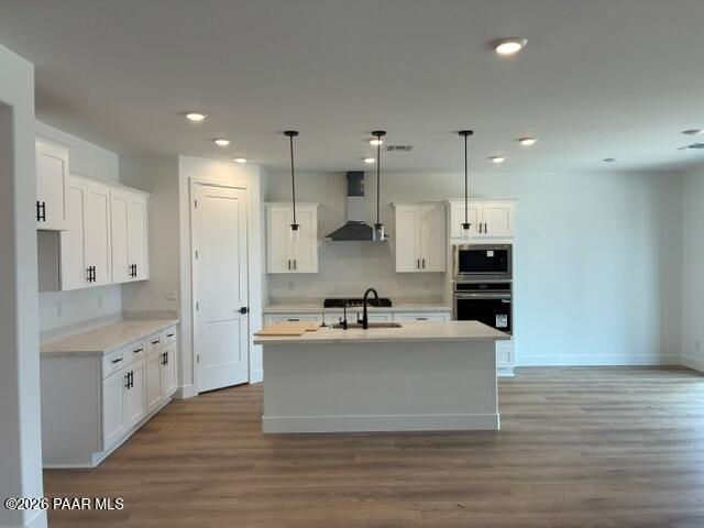 White kitchen with island, pendant lights, and stainless appliances in Davidson Homes Durango II G, Prescott, Arizona