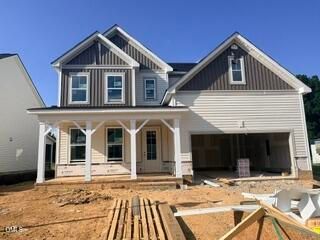 Two-story Hickory II B floor plan by Davidson Homes featuring a front porch and 2-car garage in Woodland Crossing, Zebulon.