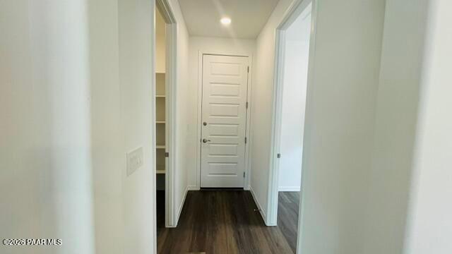 Hallway leading to a white door with an adjacent pantry in The Summit A floor plan at Westwood, Prescott, Arizona.